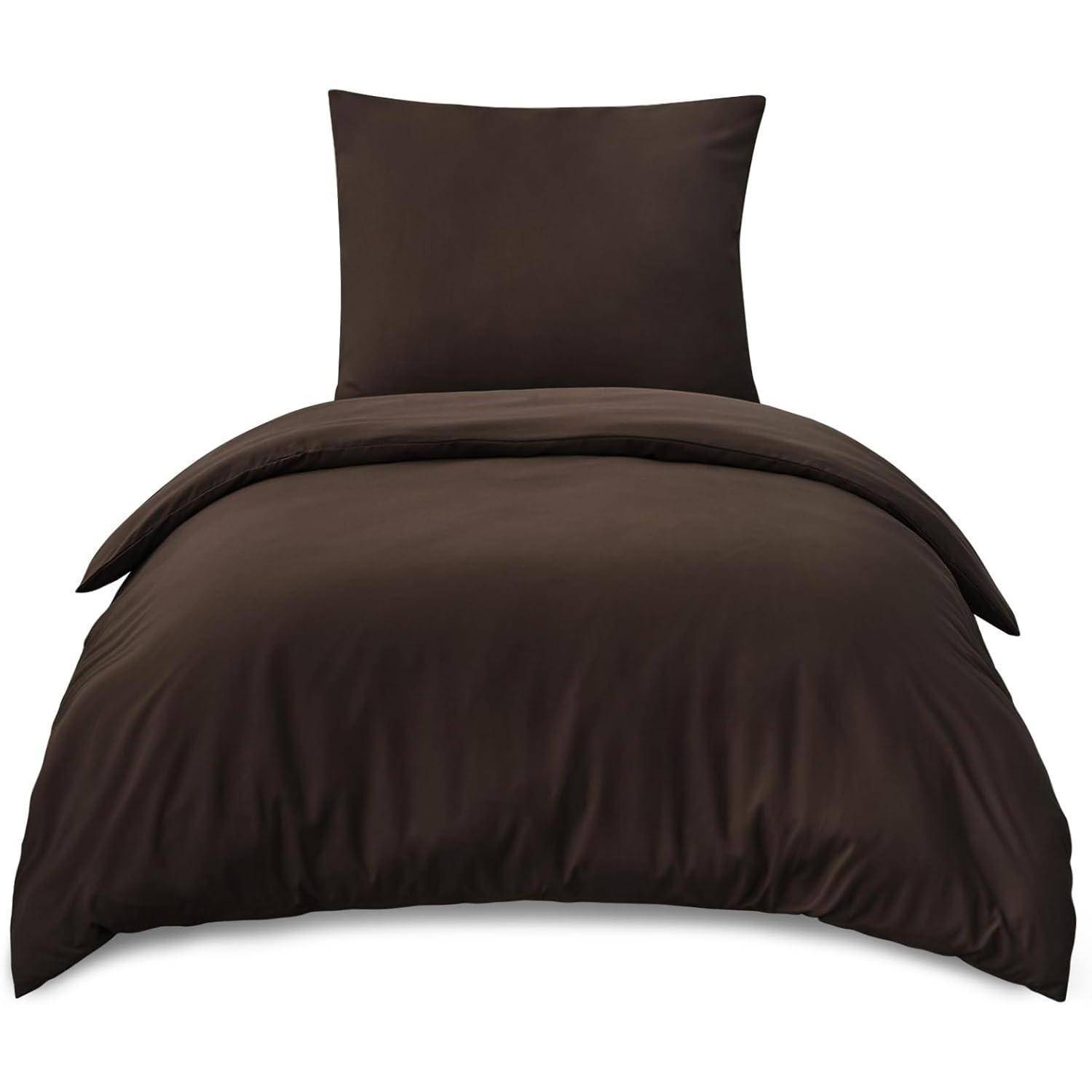 Ein ordentlich gemachtes Bett mit einem dunkelbraunen Bettbezug und passender Kissenhülle, das ein glattes und schlichtes Design präsentiert.