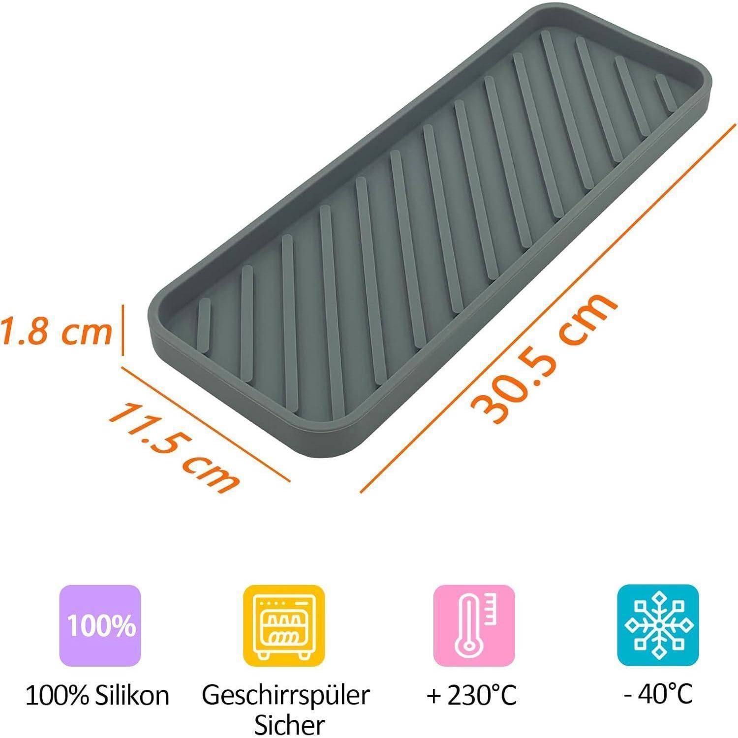 Ein grauer Silikonbehälter mit erhöhten Rillen, misst 30,5 cm x 11,5 cm und ist 1,8 cm hoch. Symbole darunter zeigen an, dass er spülmaschinenfest und temperaturbeständig von -40°C bis +230°C ist.