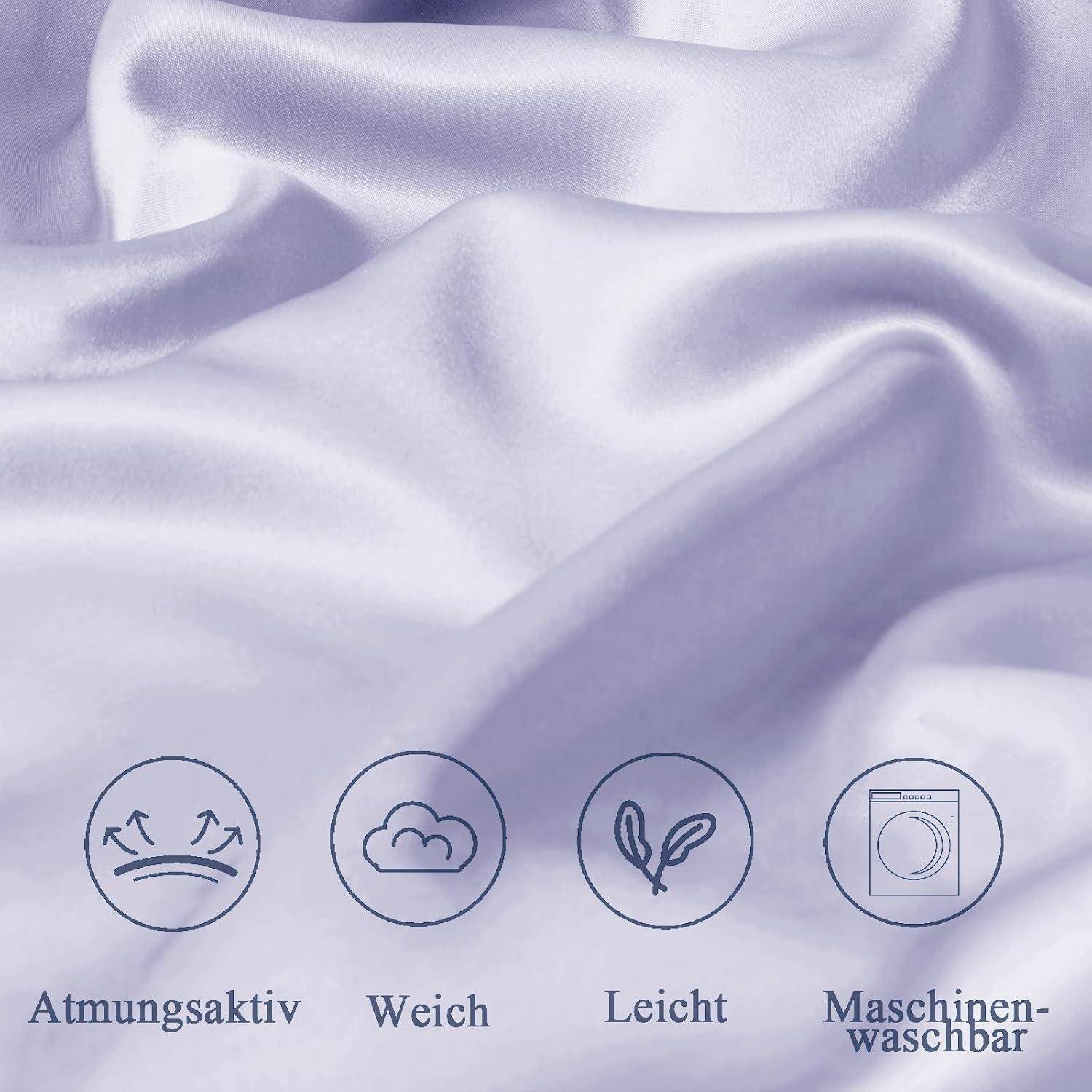 Eine Nahaufnahme von weichem, hellem Flieder-Stoff, die seine glatte Textur zeigt. Die Icons darunter weisen darauf hin, dass der Stoff atmungsaktiv, weich, leicht und waschmaschinengeeignet ist.