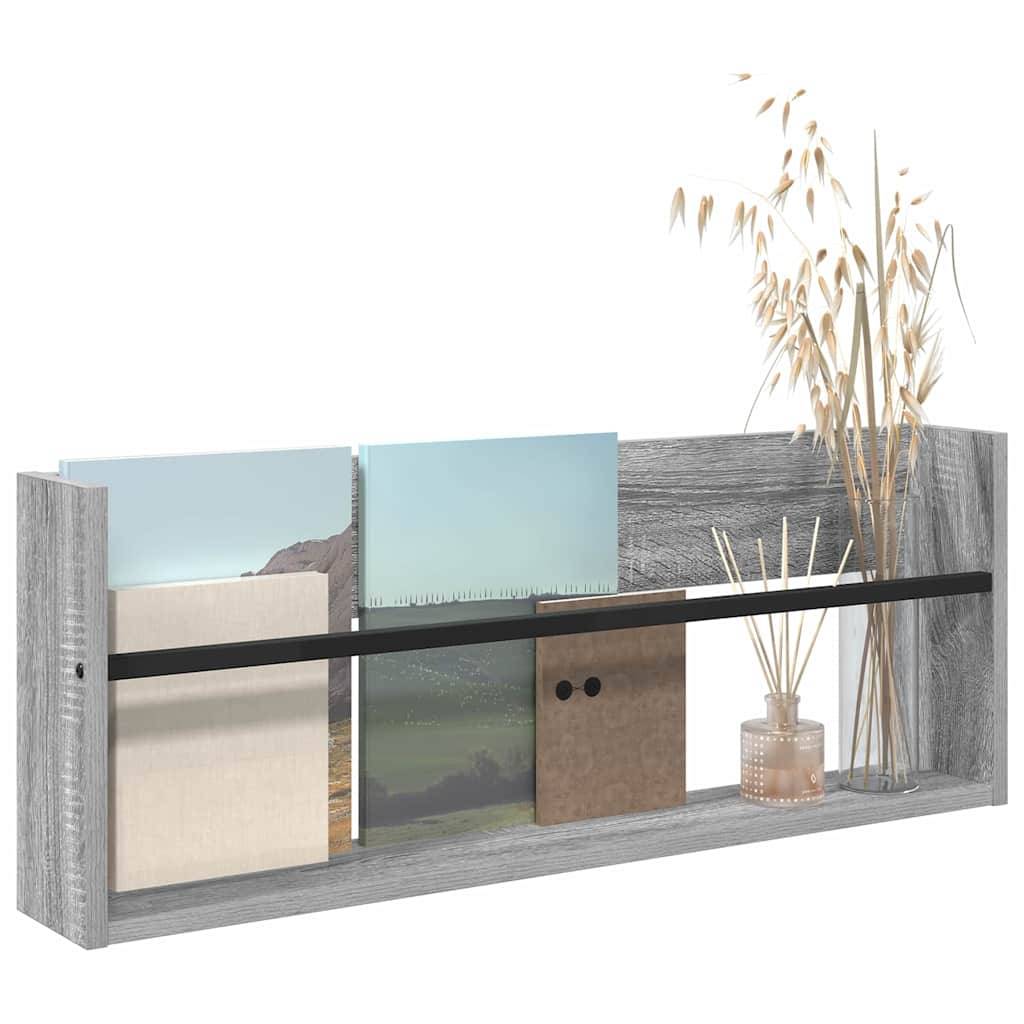 Ein Holzregal trägt eine Vase mit getrockneten Pflanzen und mehreren Büchern mit verschiedenfarbigen Einbänden, wodurch eine minimalistische Dekoration entsteht.
