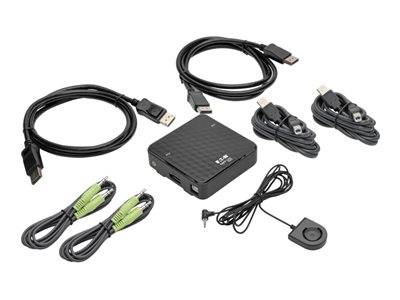 Ein schwarzes, rechteckiges elektronisches Gerät mit vier Anschlüssen, zwei USB-Kabeln, zwei Audiokabeln und einer Fernbedienung, die darum herum platziert ist.