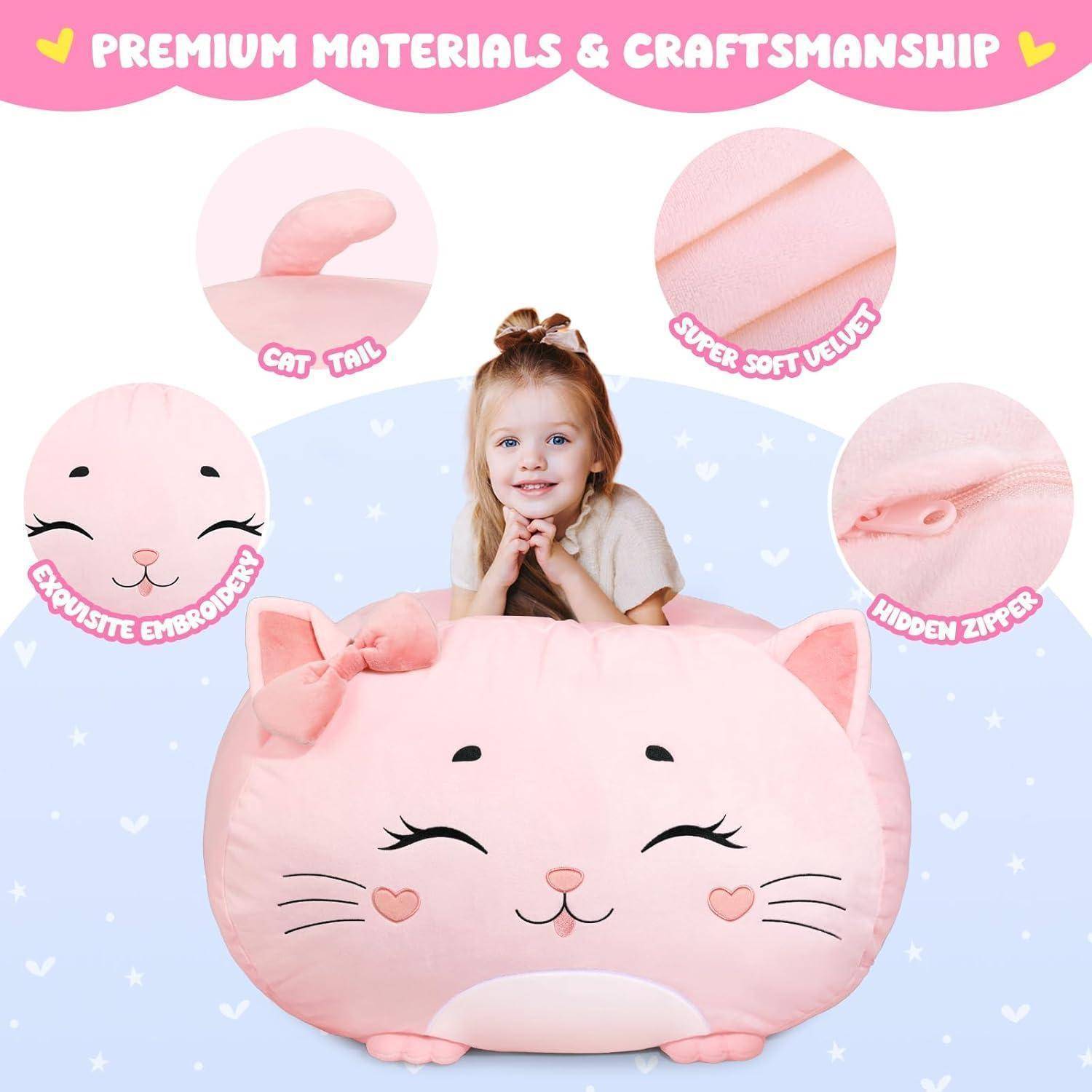 Ein junges Mädchen lächelt, während es sich auf ein großes, rosa, katzenförmiges Kissen lehnt, das mit bestickten Augen, einer Schleife, einem Katzenschwanz und einem versteckten Reißverschluss versehen ist.