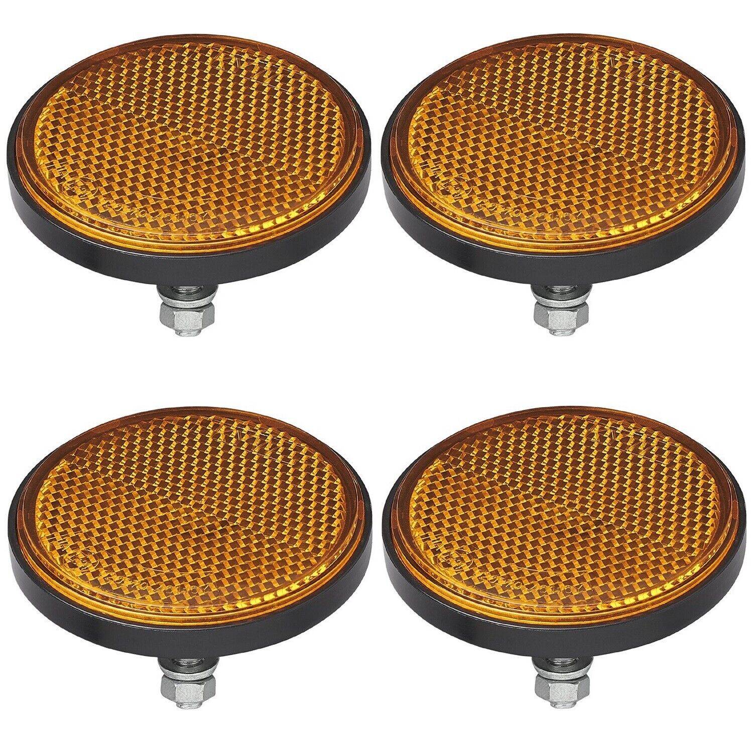 Vier runde, bernsteinfarbene Reflektoren mit Bolzenhalterungen, in zwei Reihen angeordnet, zur Verbesserung der Fahrzeugsicherheit und Sichtbarkeit.