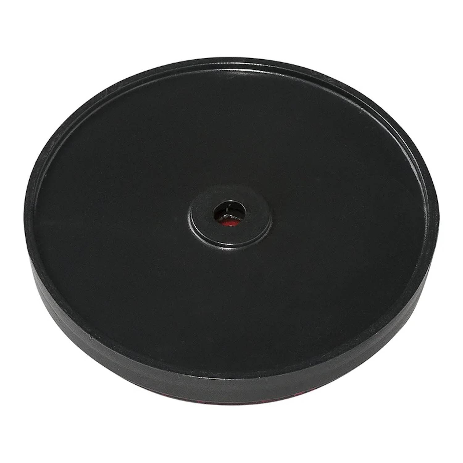 Eine runde, flache schwarze Scheibe mit einem kleinen zentralen Loch, die einer großen Taste oder einer Basis ähnelt, wird vor einem schlichten Hintergrund gezeigt.