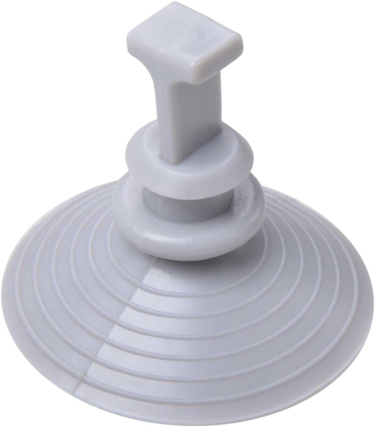 Ein Nahaufnahme eines grauen Abflussventils mit kreisförmiger, gerippter Struktur und einem T-förmigen Griff an der Oberseite.