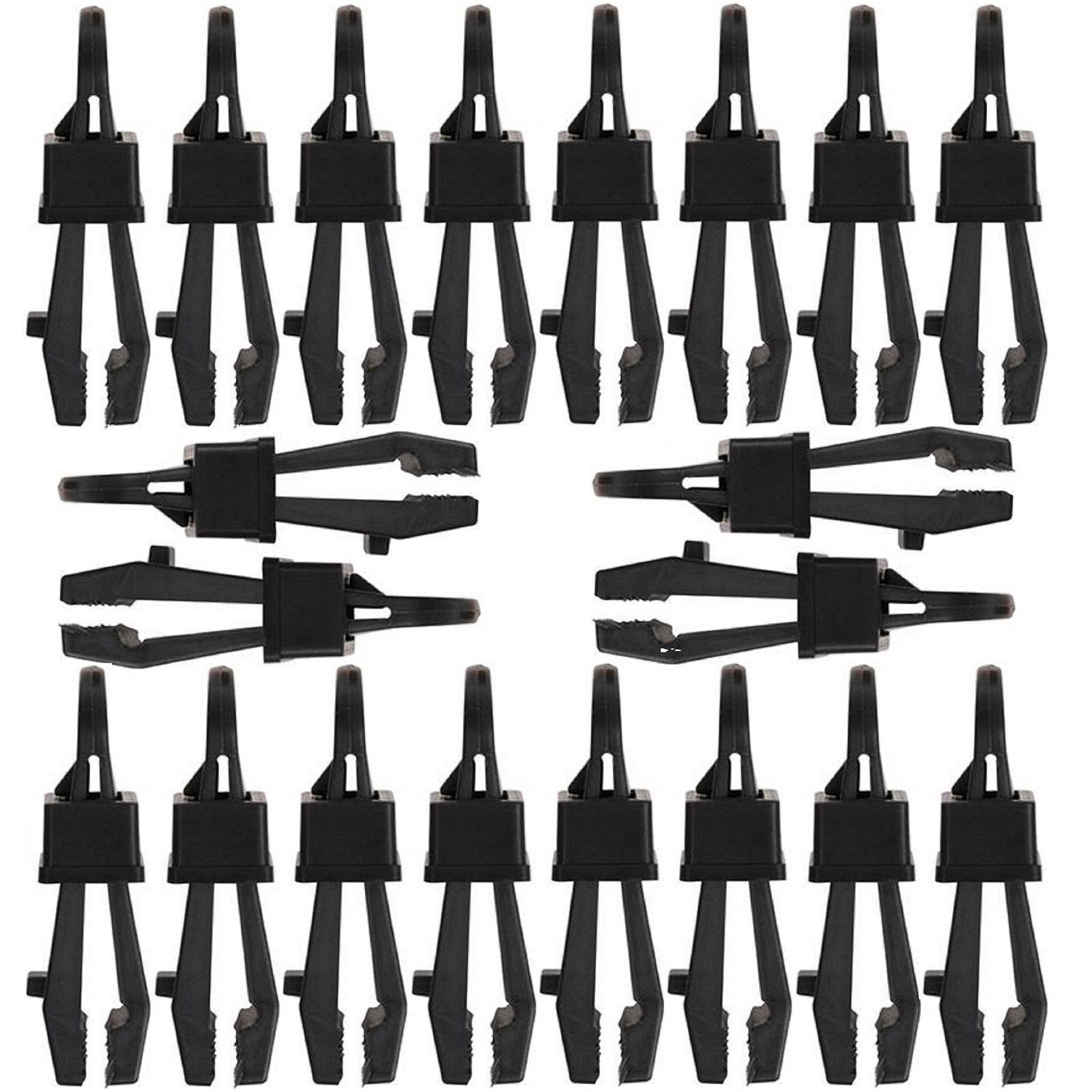Satz von schwarzen Federklemmen-Clips in Reihen auf weißem Hintergrund angeordnet.