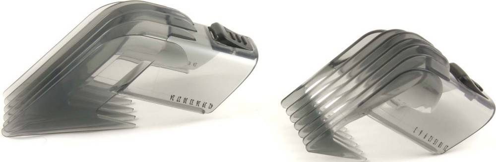 Silberne und schwarze elektrische Haarschneider mit verstellbaren Aufsteckkämmen auf einem weißen Hintergrund.