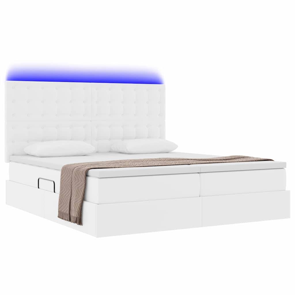 Ein modernes weißes Kingsize-Bett mit gestepptem Kopfteil und subtiler blauer LED-Beleuchtung, ausgestattet mit einer gemütlichen beigefarbenen Decke und zwei Kissen.