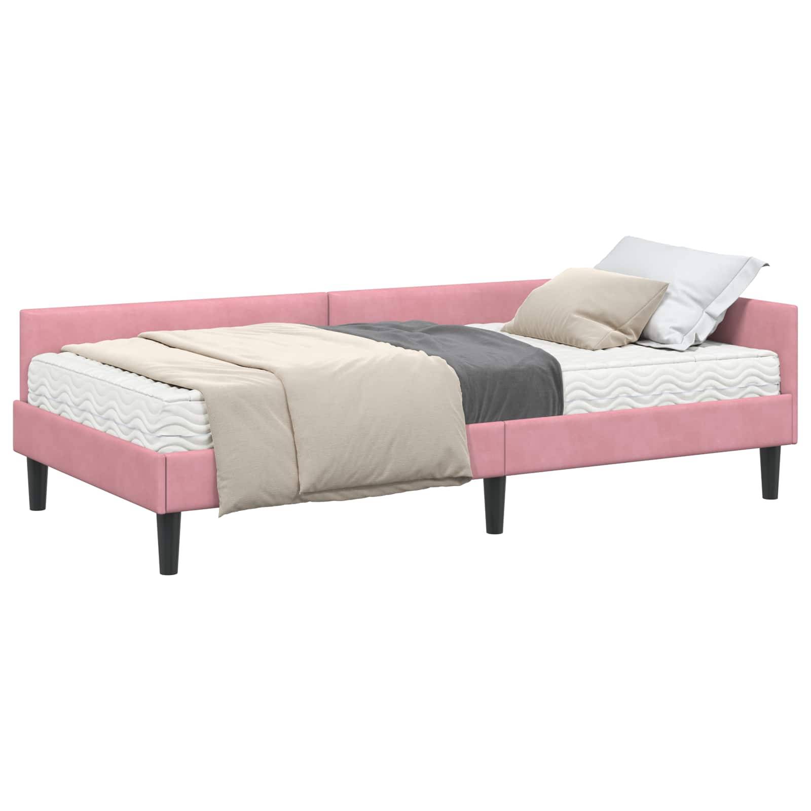 Ein pinker gepolsterter Bettrahmen mit einer Matratze, grau-beiger Bettwäsche und einem Kissen. Das Bett hat schwarze Beine und keinen Kopfteil.