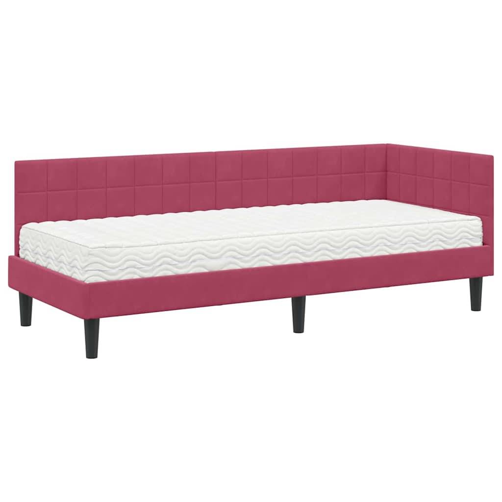 Eine rosa gepolsterte Tagesbett mit einer weißen Matratze auf schwarzen Beinen, entworfen zum Liegen oder Sitzen, geeignet für einen modernen Wohnbereich.
