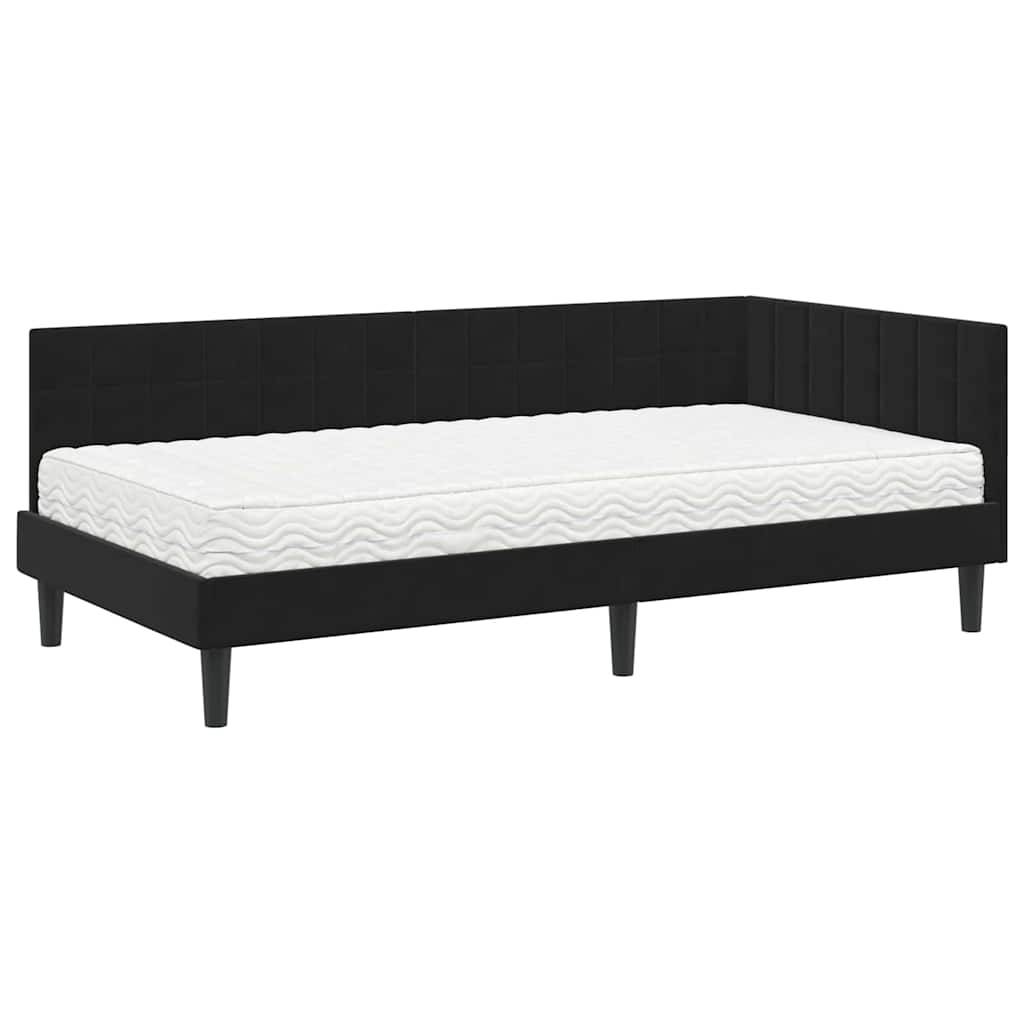 Ein schwarzes gepolstertes Tagesbett mit einer weißen Matratze, mit modernem Design und Holzbeinen, aus einer Seitenansicht gezeigt.