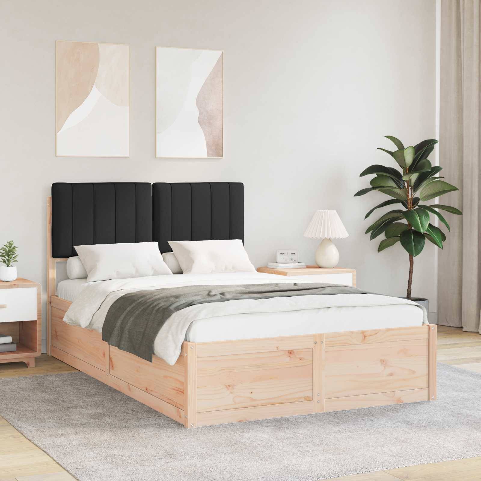 Ein modernes Schlafzimmer mit einem Bettgestell aus Holz, schwarzem Kopfteil, weißer und grauer Bettwäsche, zwei abstrakten Gemälden, einem Nachttisch mit einer Lampe und einer Zimmerpflanze.