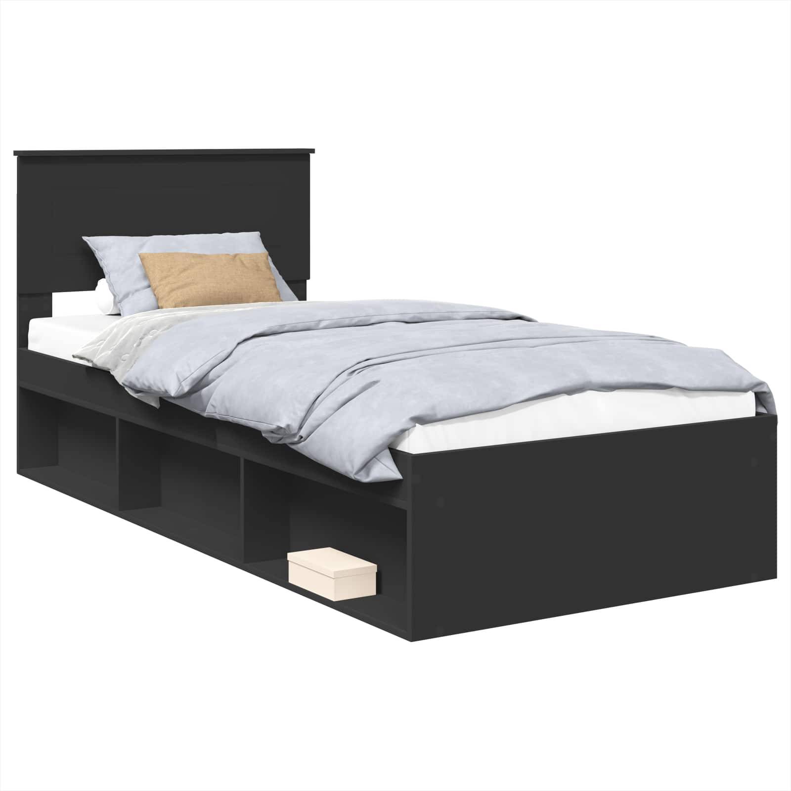 Ein einzelnes schwarzes Bett mit einer hellgrauen Bettdecke und Kissen. Das Bett verfügt über Stauraum-Fächer darunter, wobei eine sichtbare Schachtel im Inneren zu sehen ist.