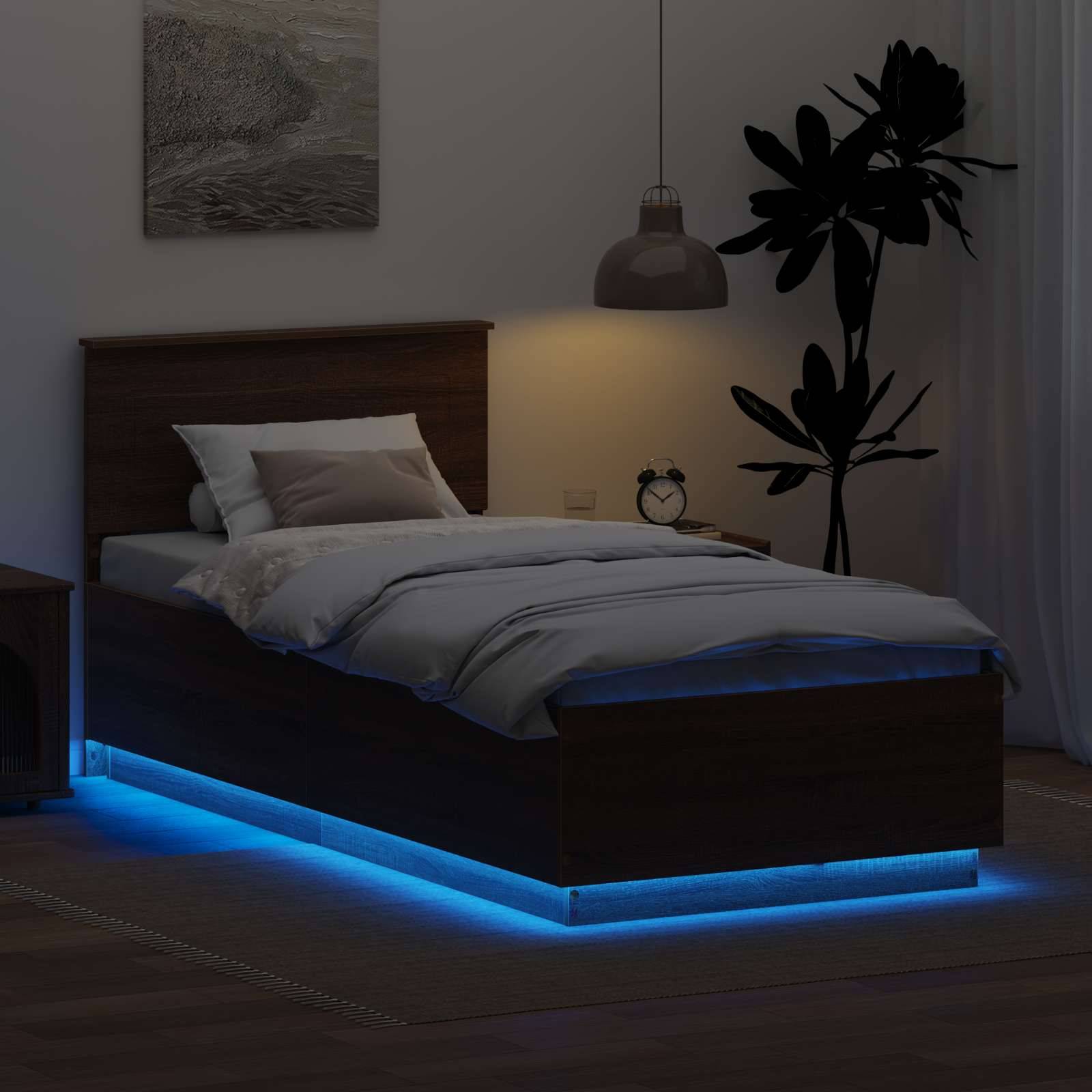 Ein dämmriger Schlafraum mit einem Holzbett, das von blauen LED-Lichtern von unten beleuchtet wird. Eine hohe Pflanze und ein Nachttisch mit einer Lampe befinden sich in der Nähe.