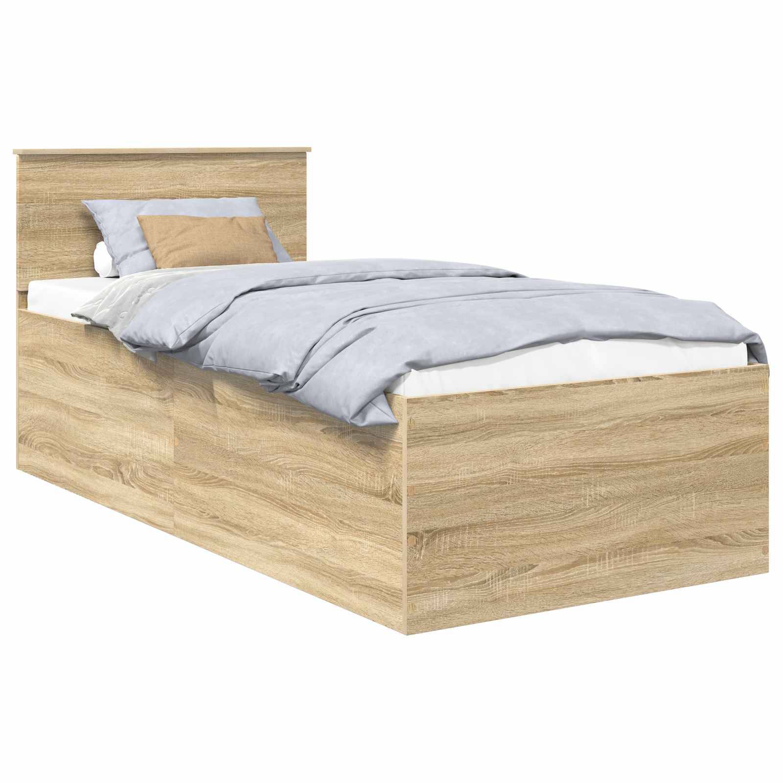Ein Holz-Einzelbett mit heller Holzoberfläche, ordentlich bezogen mit einer blau-grauen Bettdecke und zwei Kissen, eines in blau-grau und eines in beige.