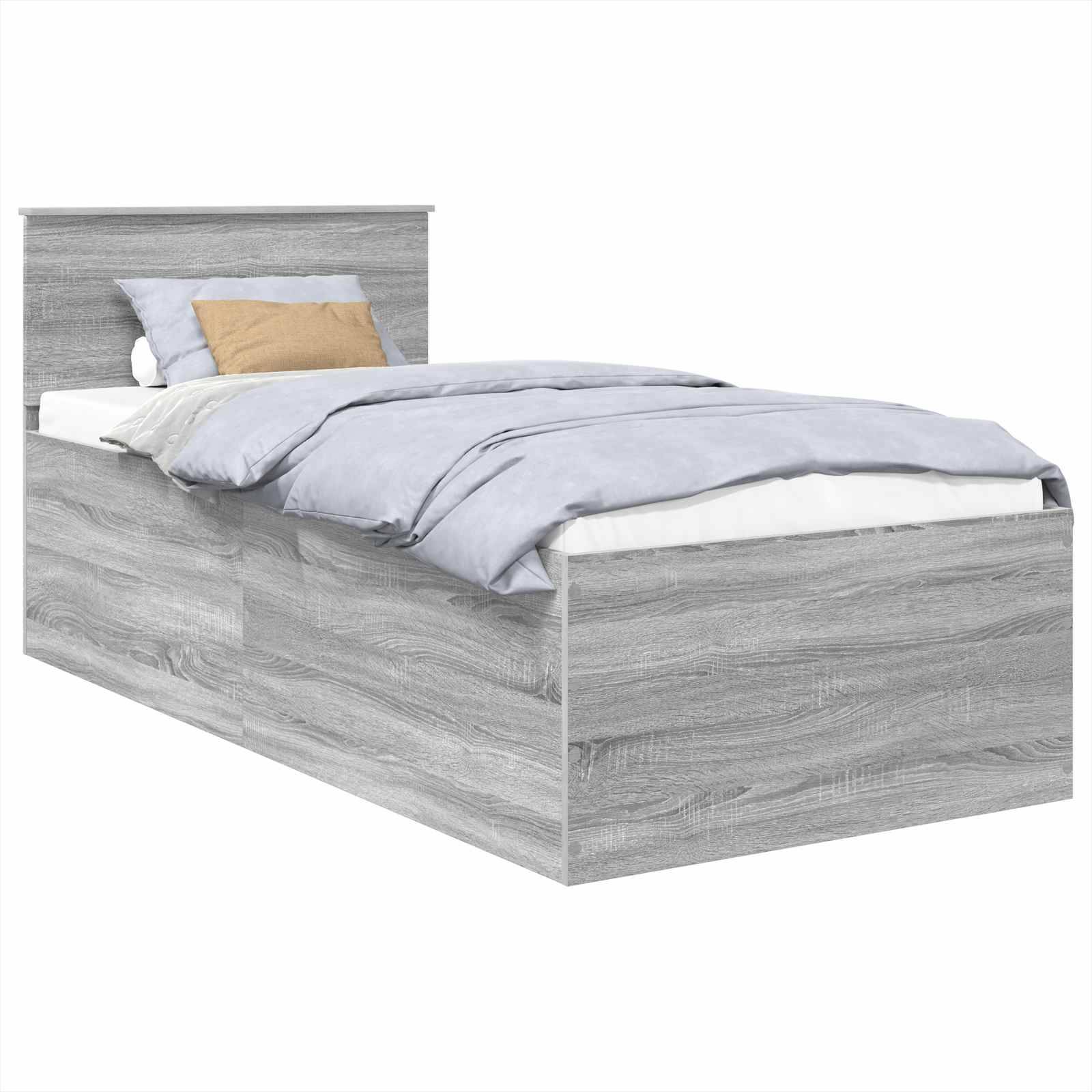 Ein graues Holzbett in Einzelgröße mit Kopfteil, ordentlich gemacht mit einer hellblauen Bettdecke und drei Kissen, einem beigen und zwei blauen.