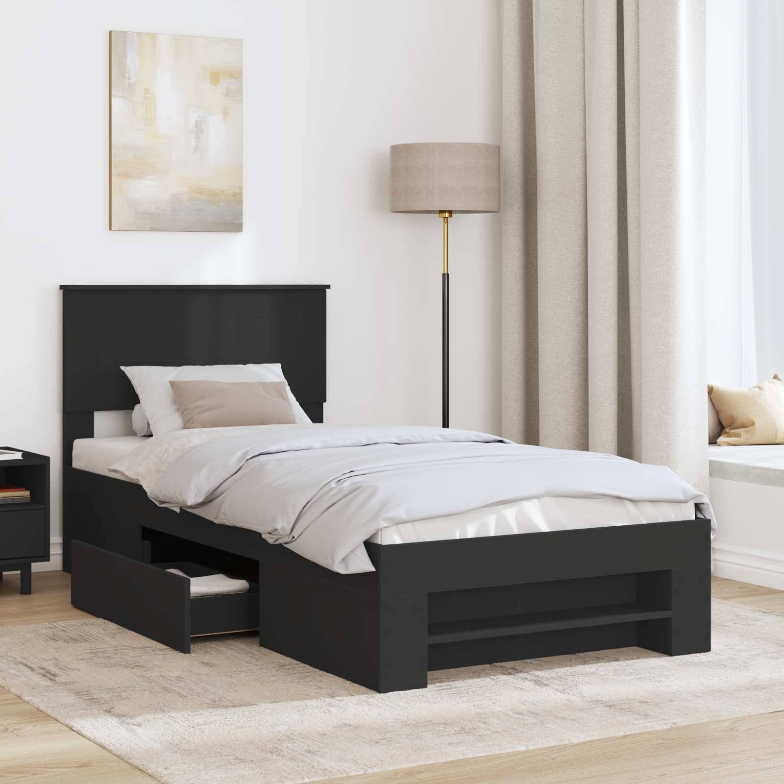 Ein modernes Schlafzimmer mit einem einzelnen Bett aus dunklem Holz, weißer Bettwäsche, ausziehbaren Schubladen darunter, einem Nachttisch, einer Lampe und abstrakter Wandkunst.