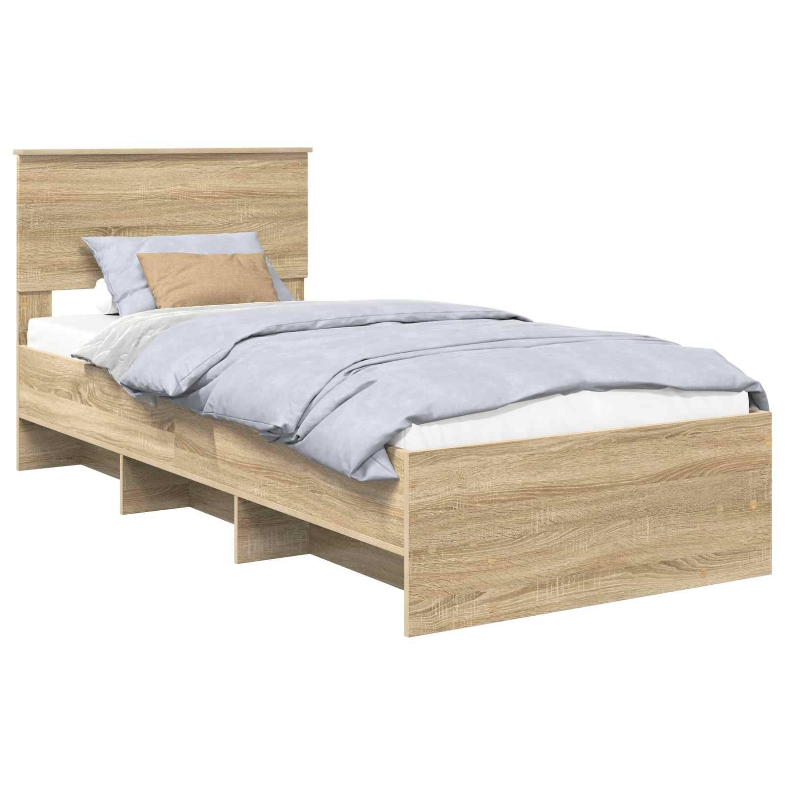 Ein Holz-Doppelbett mit einem schlichten Kopfteil und hellgrauer Bettwäsche, ausgestattet mit mehreren Stauraummöglichkeiten darunter.