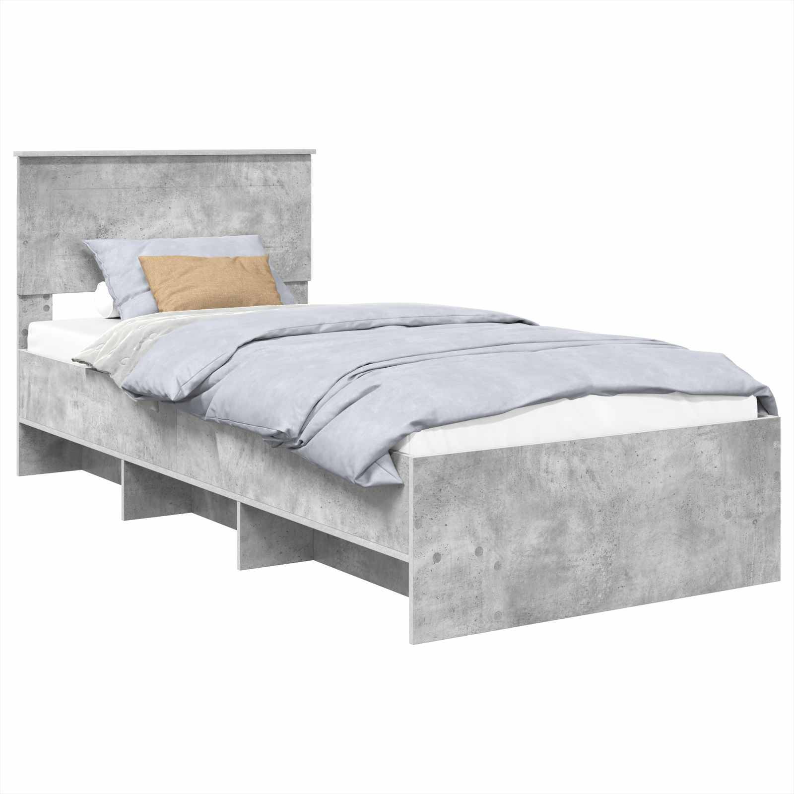 Ein Einzelbett mit einem Rahmen in Betonoptik in Grau, ausgestattet mit integrierten Ablageregalen und bezogen mit grauer Bettwäsche und einem beigen Kissen.