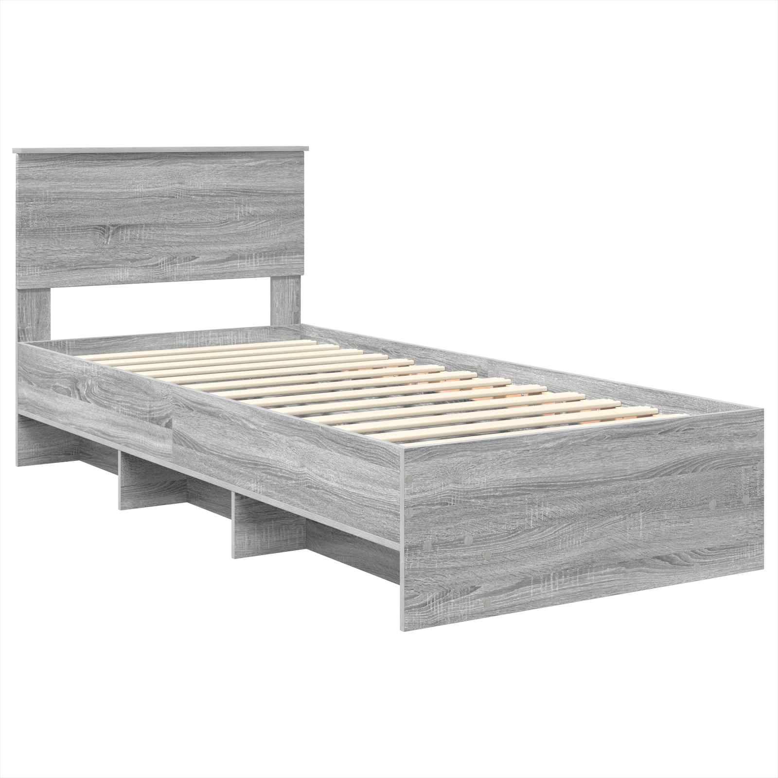Ein grauer, hölzerner Zwillingsbettrahmen mit Kopfteil und Stauraum unter dem Bett, ohne Matratze dargestellt.