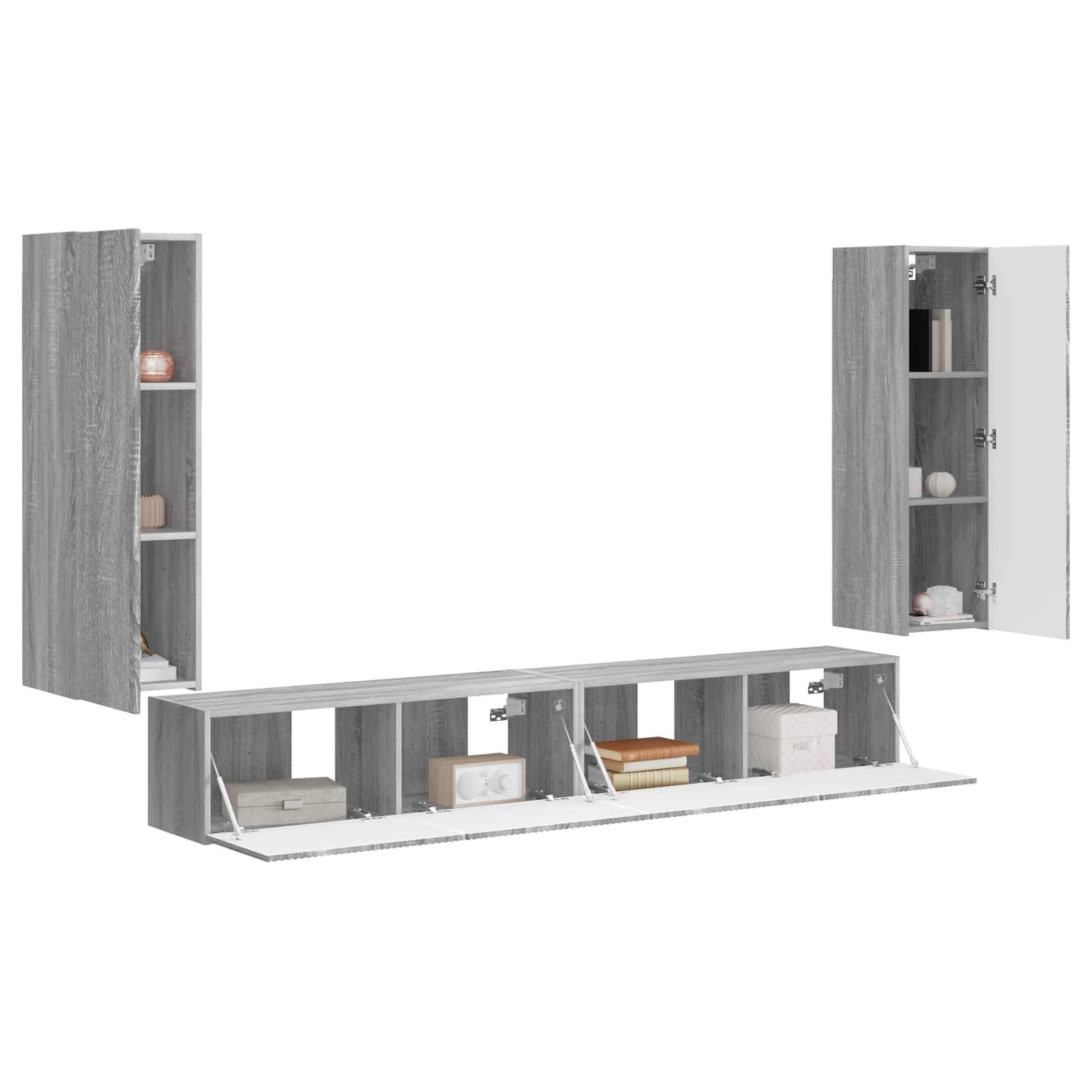 Ein modulares RegalSystem mit grauer Holzstruktur, das offene und geschlossene Schränke mit Büchern, Dekoration und Aufbewahrungsboxen präsentiert.