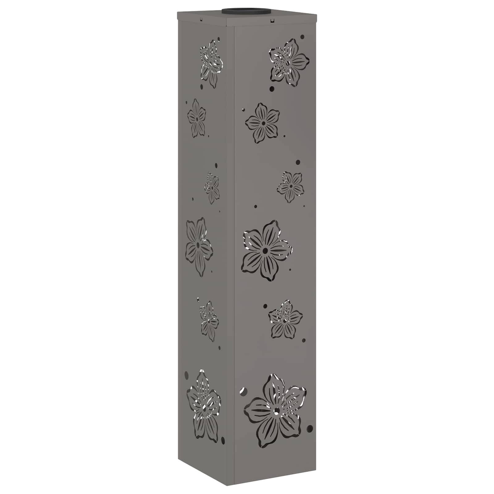 Eine hohe, rechteckige, graue Metallbox mit dekorativen Blumenausschnitten auf allen Seiten.