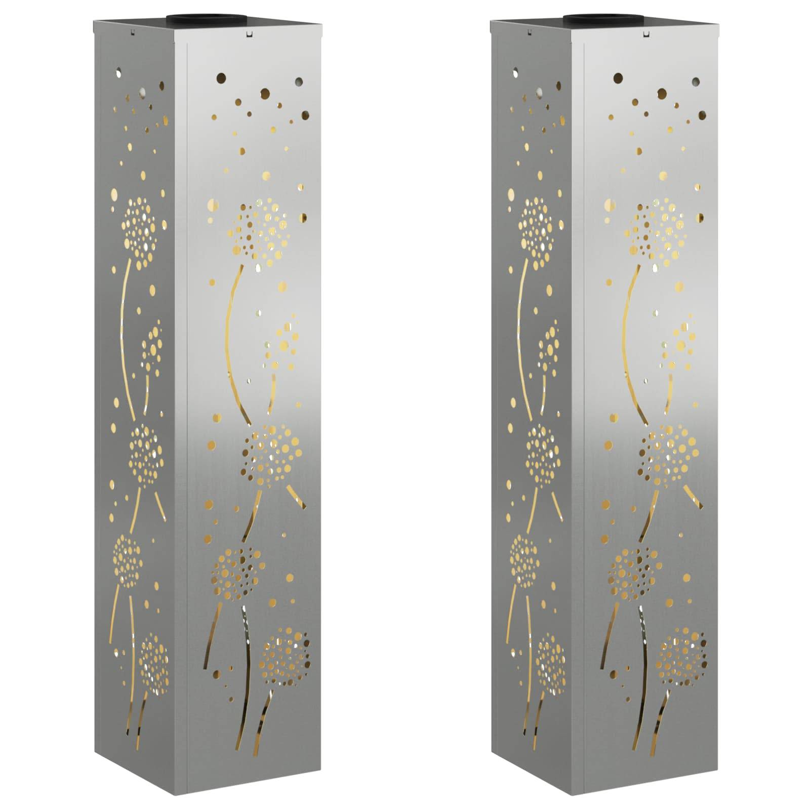 Zwei metallfarbene rechteckige Laternen mit kunstvollen Blumenmustern. Sanftes Licht schimmert durch die floralen Ausschnitte.