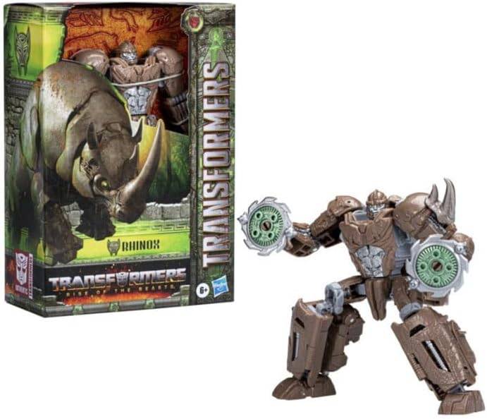Ein Transformers-Spielzeugroboter, der einem Rhinozeros sowohl in Roboter- als auch in Tierform ähnelt, neben seiner Verpackungsbox mit detaillierter Kunstdarstellung.