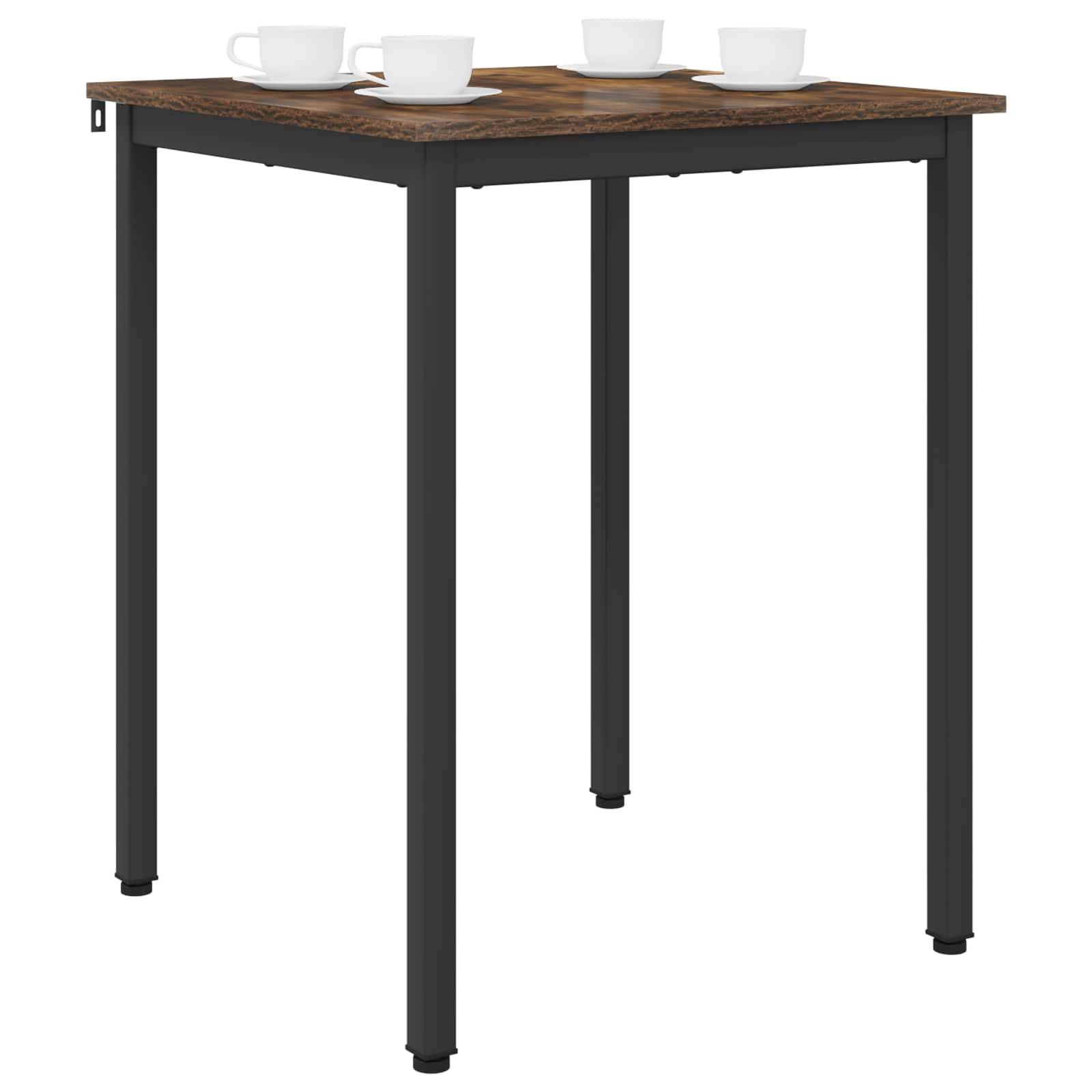 Ein quadratischer Holztisch mit schwarzen Metallbeinen trägt drei weiße Tassen und deutet eine lässige Kaffee-Arrangement an.