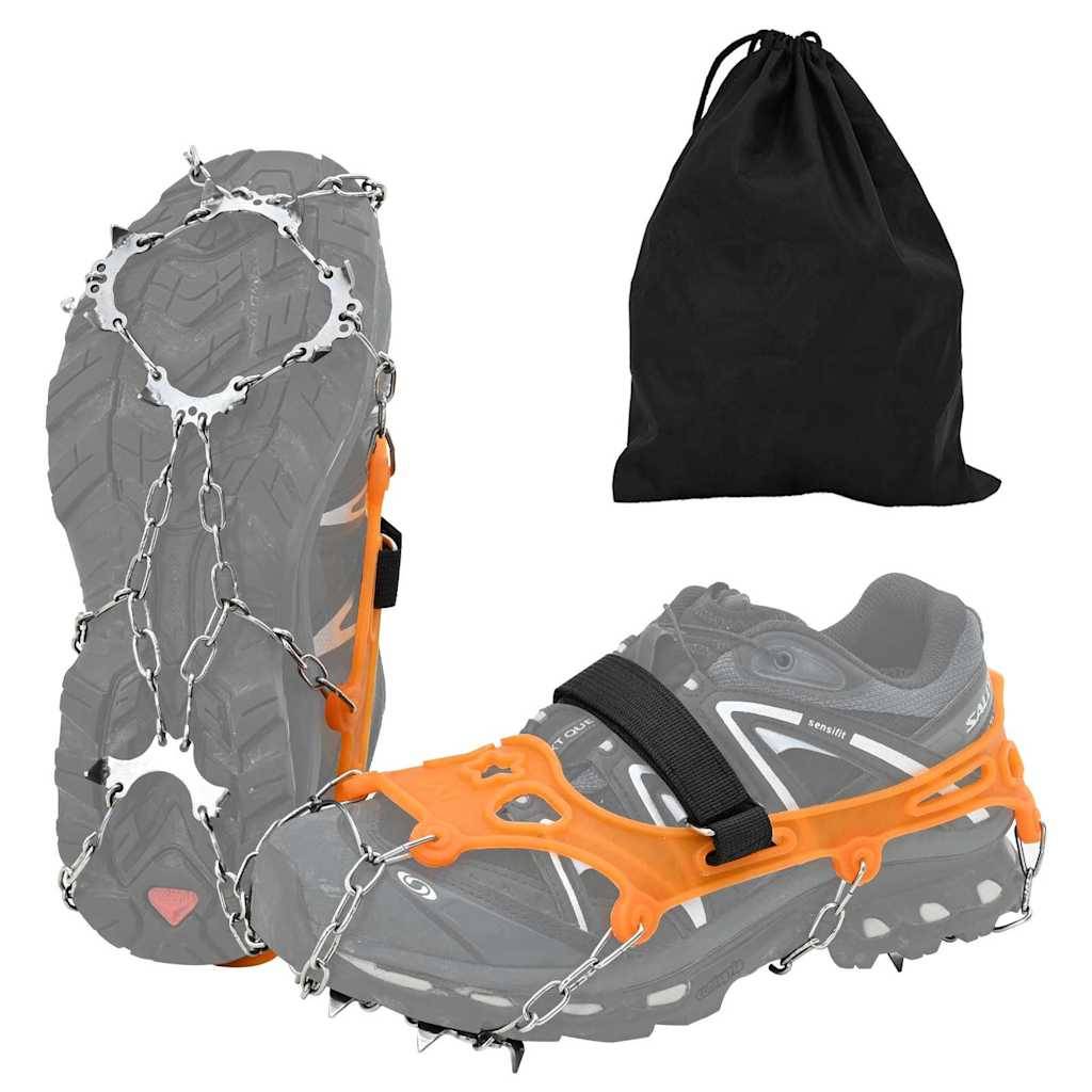 Graue Wanderschuhe mit orangefarbenen Steigeisen, ausgestattet mit Metallspitzen und Ketten, zusammen mit einer schwarzen Aufbewahrungstasche, geeignet für schneebedecktes Gelände.