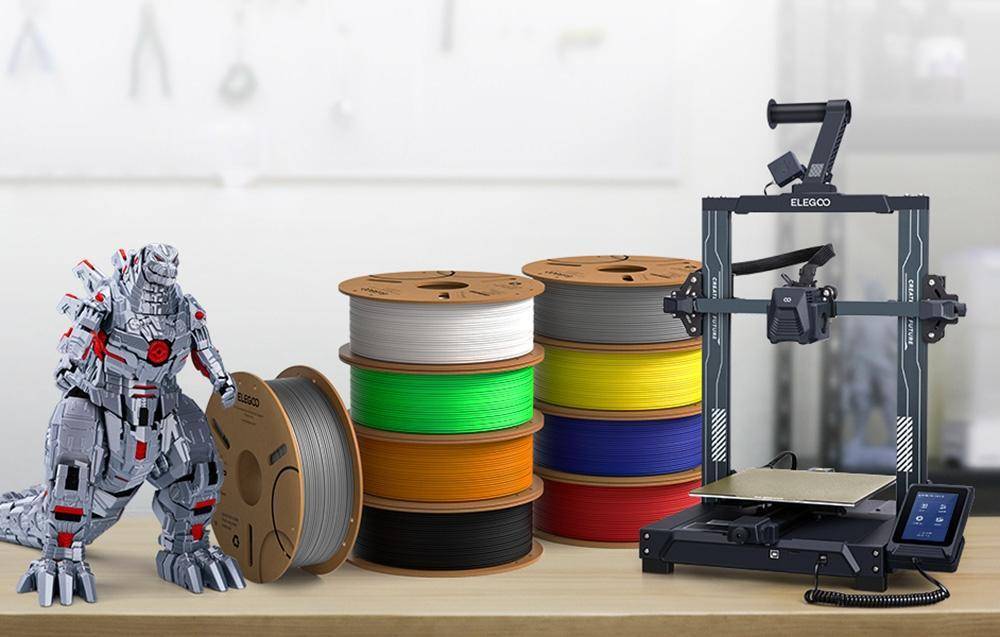 3D-Drucker auf einem Tisch mit mehrfarbigen Filamentspulen, darunter weiß, grün, orange und schwarz, was einen Bastelarbeitsplatz andeutet.