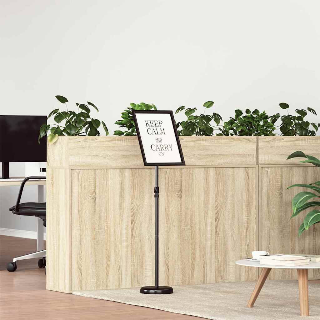 Ein hölzerner Raumteiler mit Pflanzen trägt ein kleines Schild mit der Aufschrift 