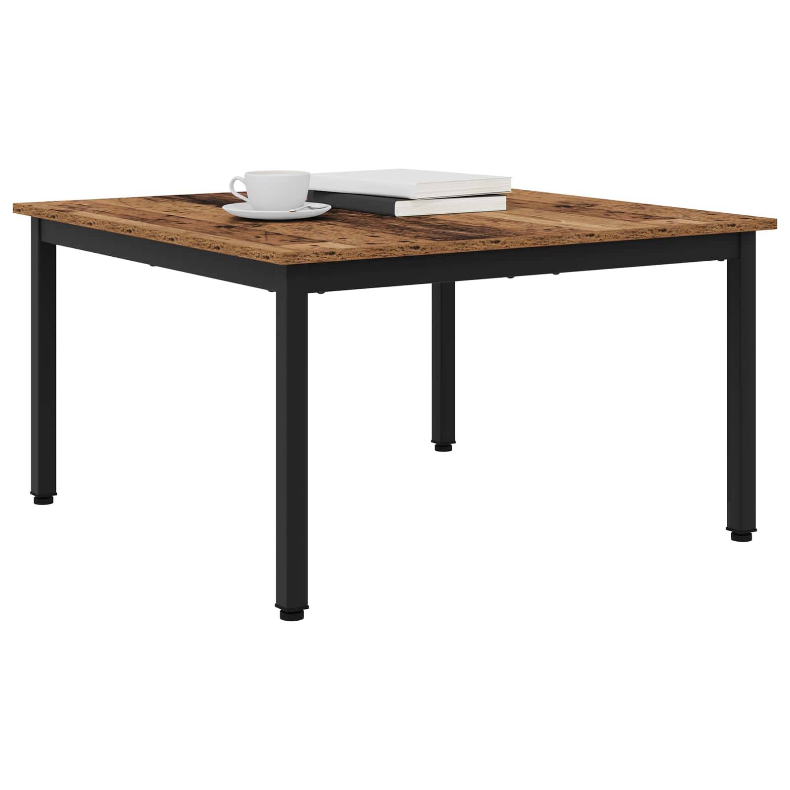 Ein Holztisch in Quadratform mit schwarzen Beinen, auf dem eine weiße Tasse und ein geschlossenes Buch stehen, in einer hellen Umgebung platziert.