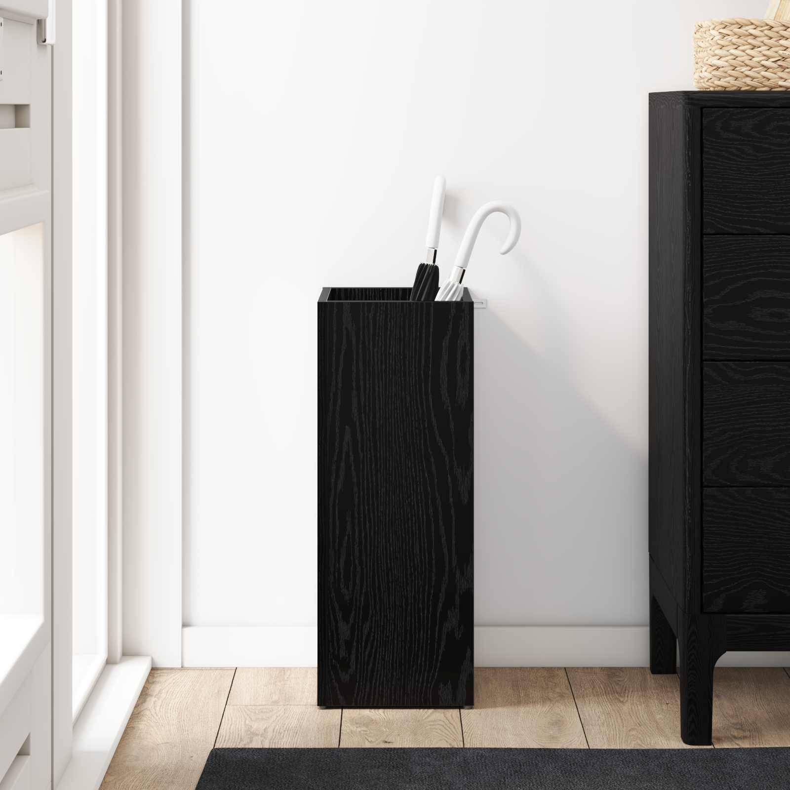 Eine moderne Küchenecke mit einem schwarzen Holz-Schirmständer mit Schirmen, neben einem hohen dunklen Holzschrank auf einem Holzboden.