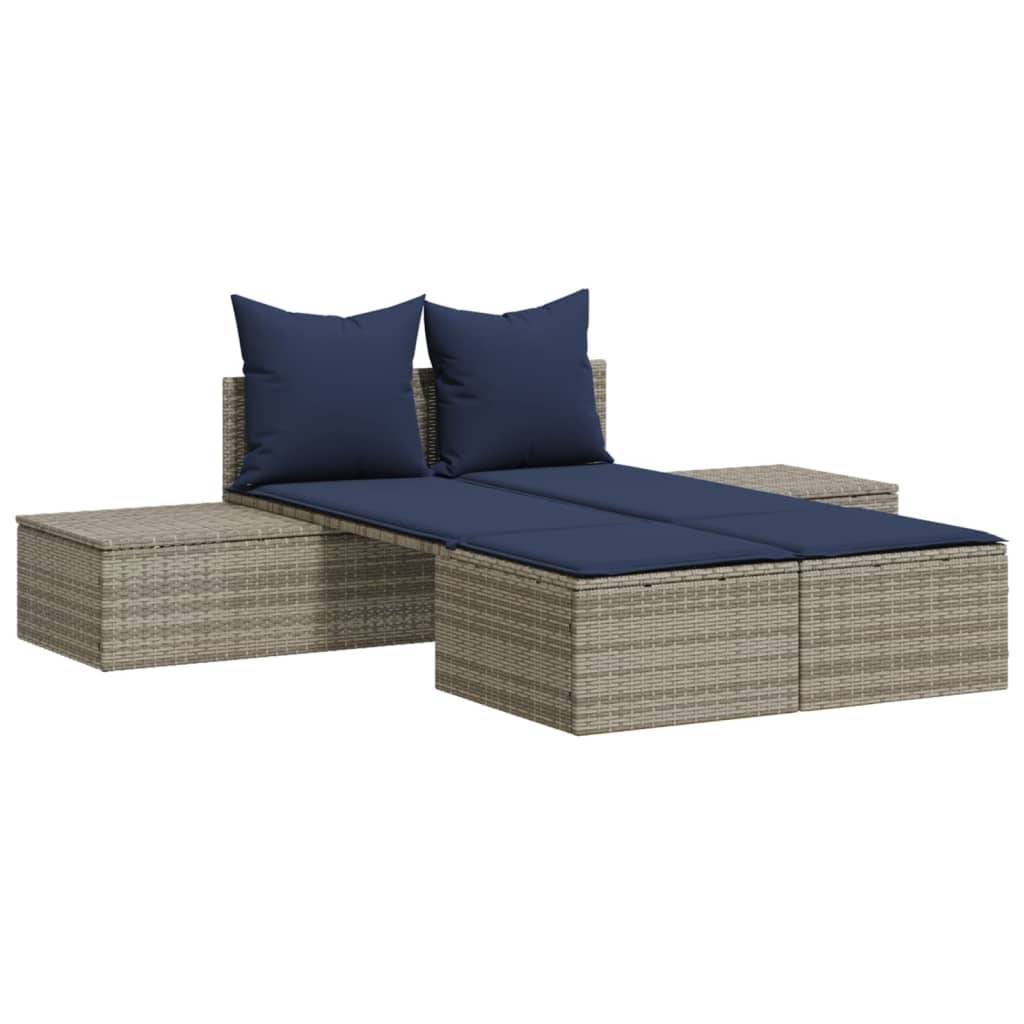 Outdoor Ecksofa mit zwei blauen Kissen, das ein Rattandesign und eine modulare Anordnung aufweist. Geeignet für Garten- oder Terrassenbestuhlung.