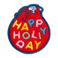 Roter Fleck mit blauem Rand, auf dem der Weihnachtsmann zu sehen ist und die Worte 'Frohe Feiertage' in mehrfarbigen Buchstaben stehen.
