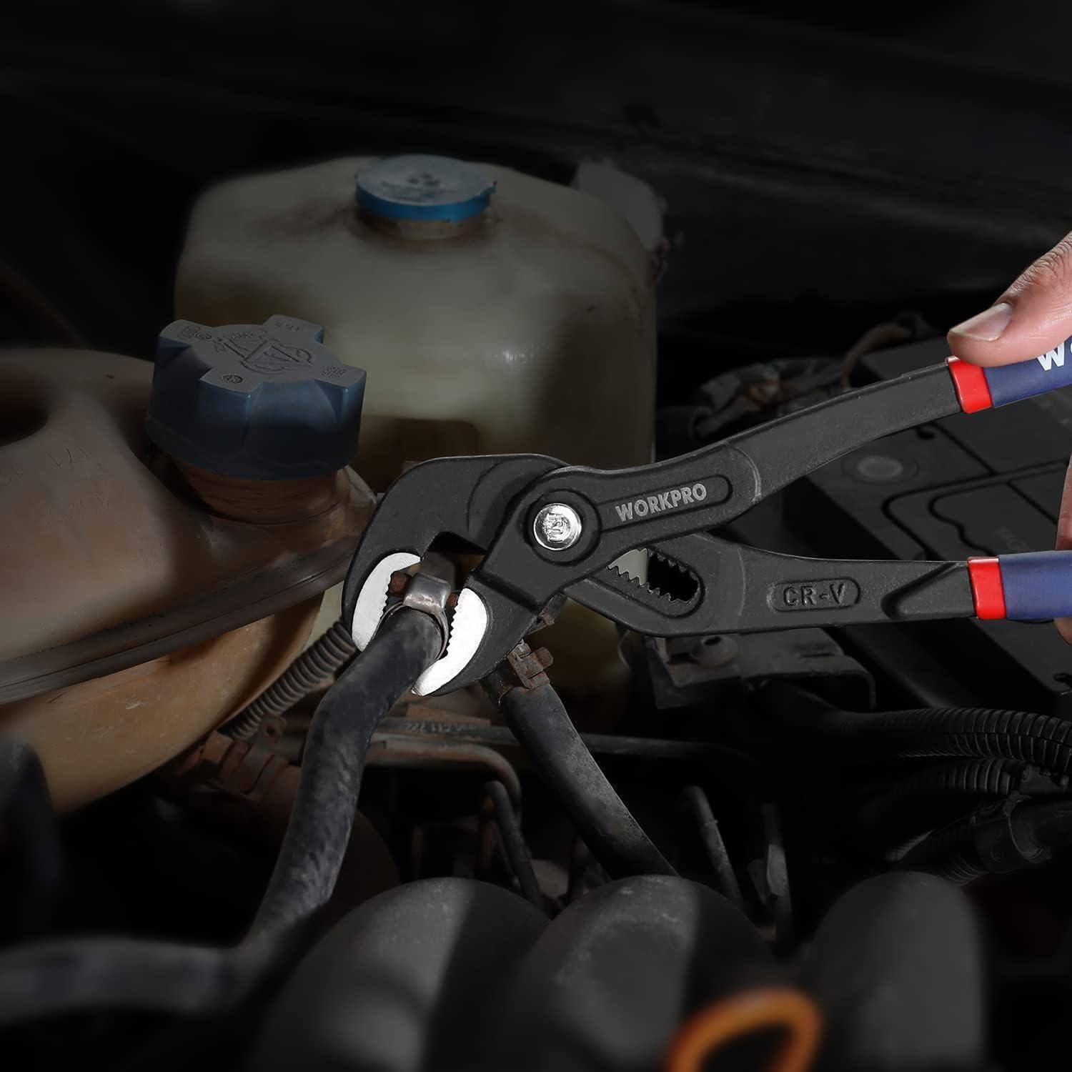 Eine Zange umgreift einen Autoschlauch in einem dunkel beleuchteten Motorraum. Der Fokus liegt auf der Verwendung des Werkzeugs bei der Automotive-Wartung oder -Reparatur.