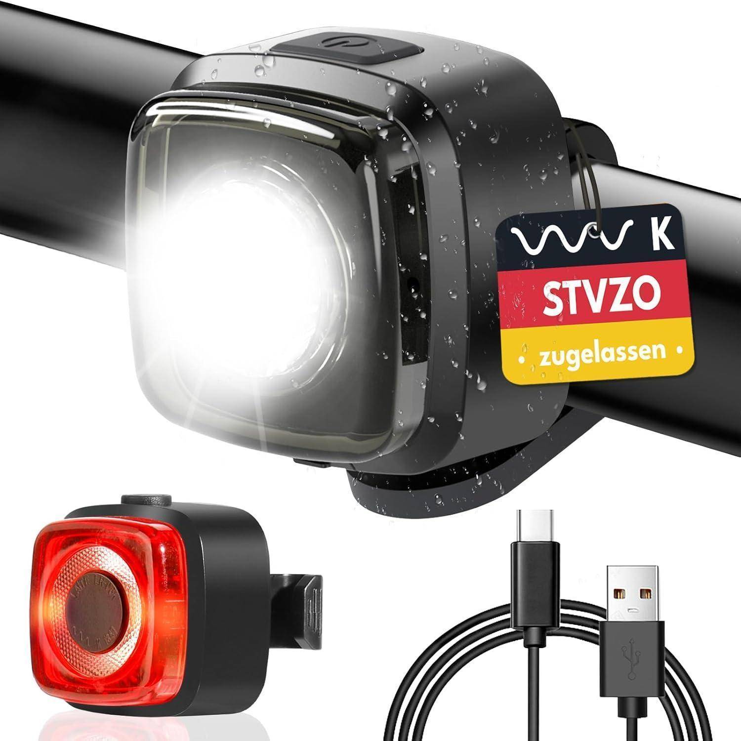 Ein Fahrrad-Vorder- und Rücklicht-Set; das Vorderlicht ist wasserdicht und montiert, sendet einen hellen Lichtstrahl. USB-Ladekabel im Lieferumfang enthalten.