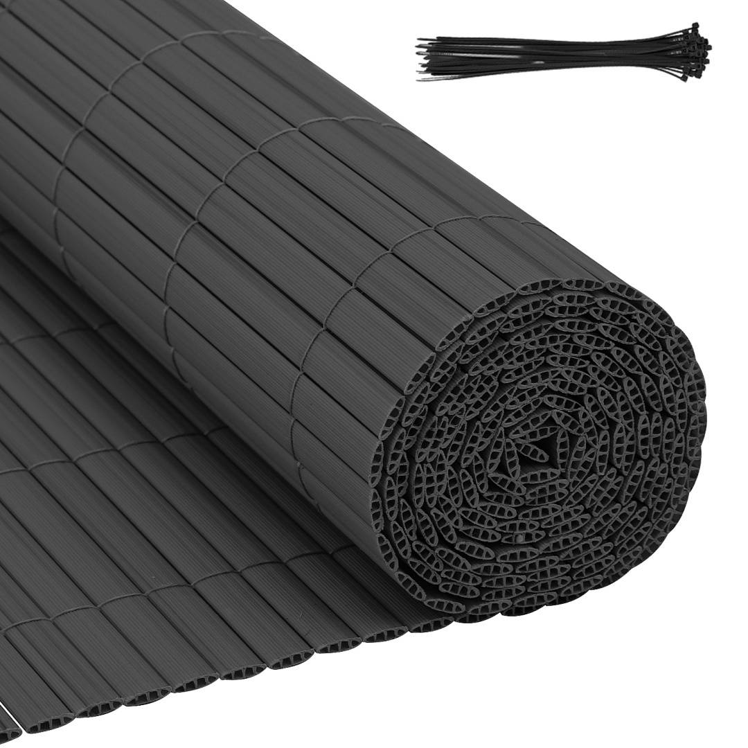 Eine Rolle schwarzer wellförmiger Kunststoffplatten mit einem Stapel schwarzer Kabelbinder daneben.