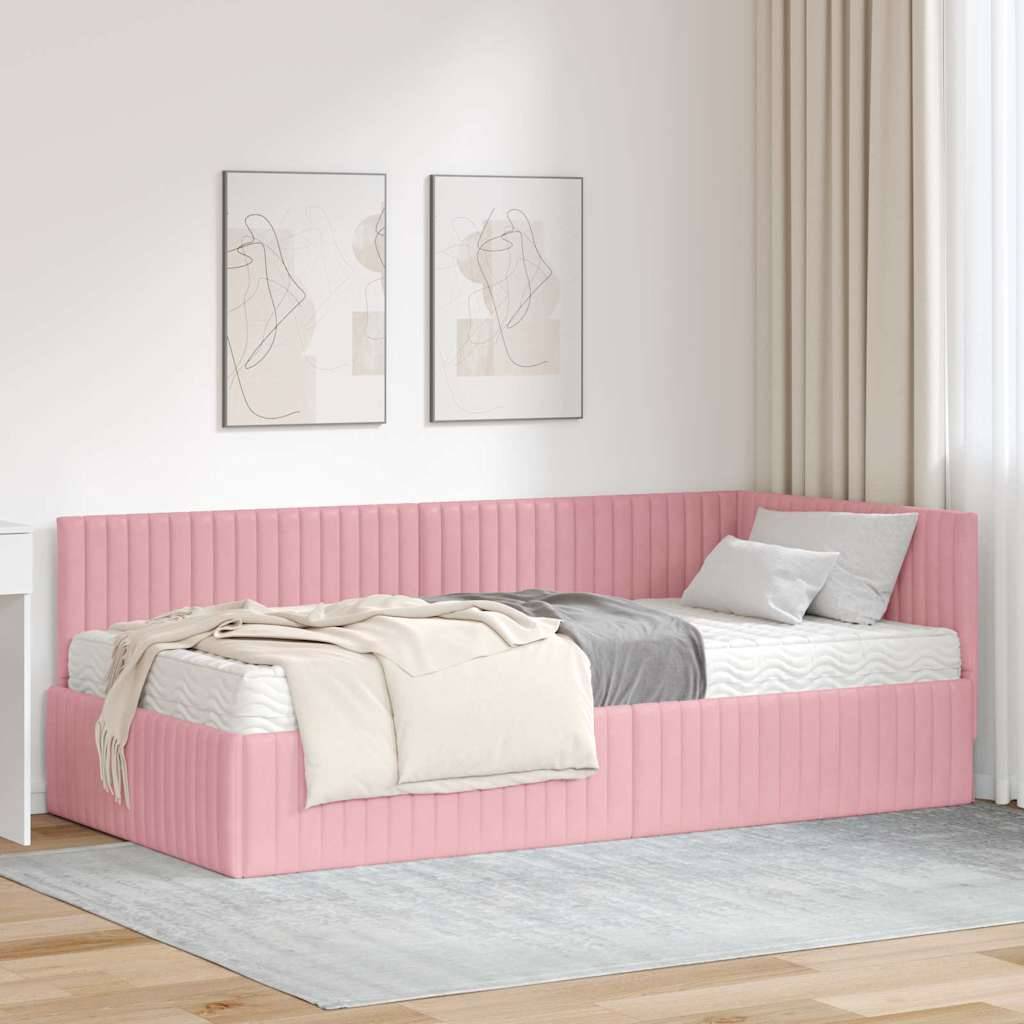 Rosa Tagesbett mit beige und grauen Kissen und Decken, platziert in einem minimalistischen Raum mit zwei abstrakten Kunstwerken und einem weißen Schreibtisch.