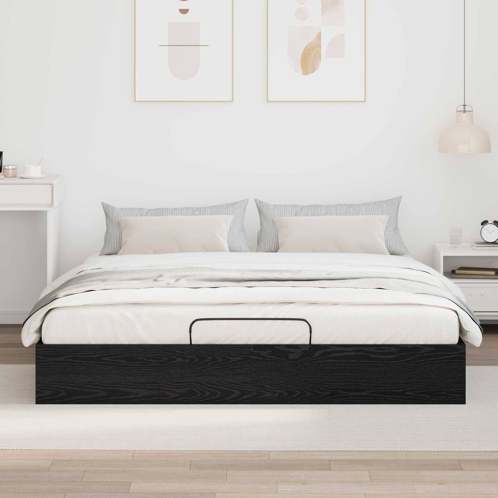Ein modernes Schlafzimmer mit einem ordentlich gemachten Bett mit grauen und weißen Kissen, einem Nachttisch mit Dekor und minimalistischen gerahmten Kunstwerken darüber.