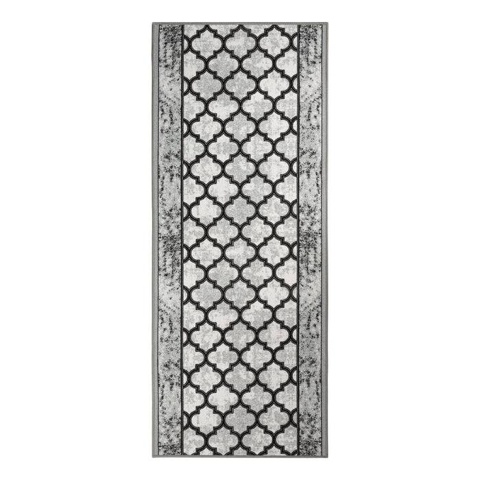 Ein rechteckiger Teppich mit einem geometrischen Muster aus überlappenden Bögen in Schwarz und Weiß, umrahmt von einem verwitterten grauen Design.