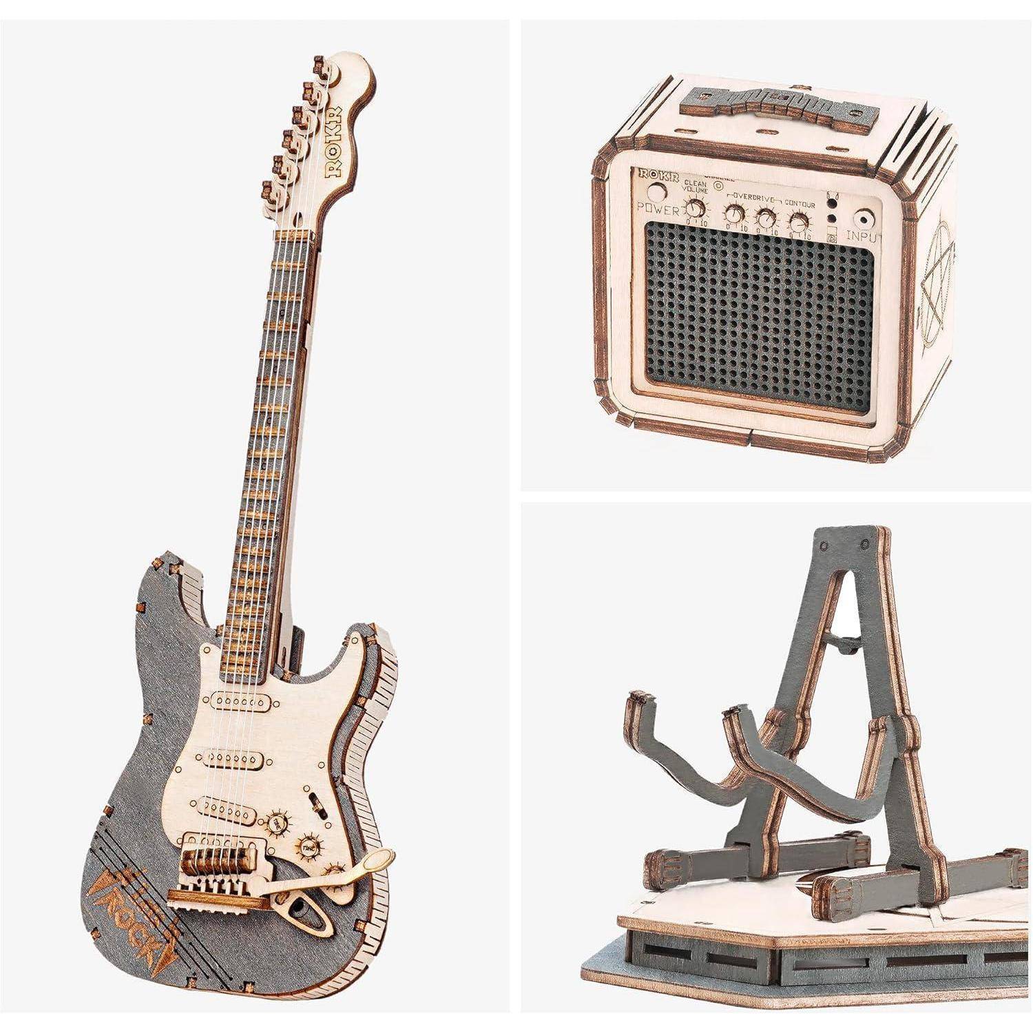 Ein Set aus drei Holz-Musikmodellen: eine E-Gitarre, ein Verstärker und ein Ständer, alle mit feinen Details sorgfältig gearbeitet.