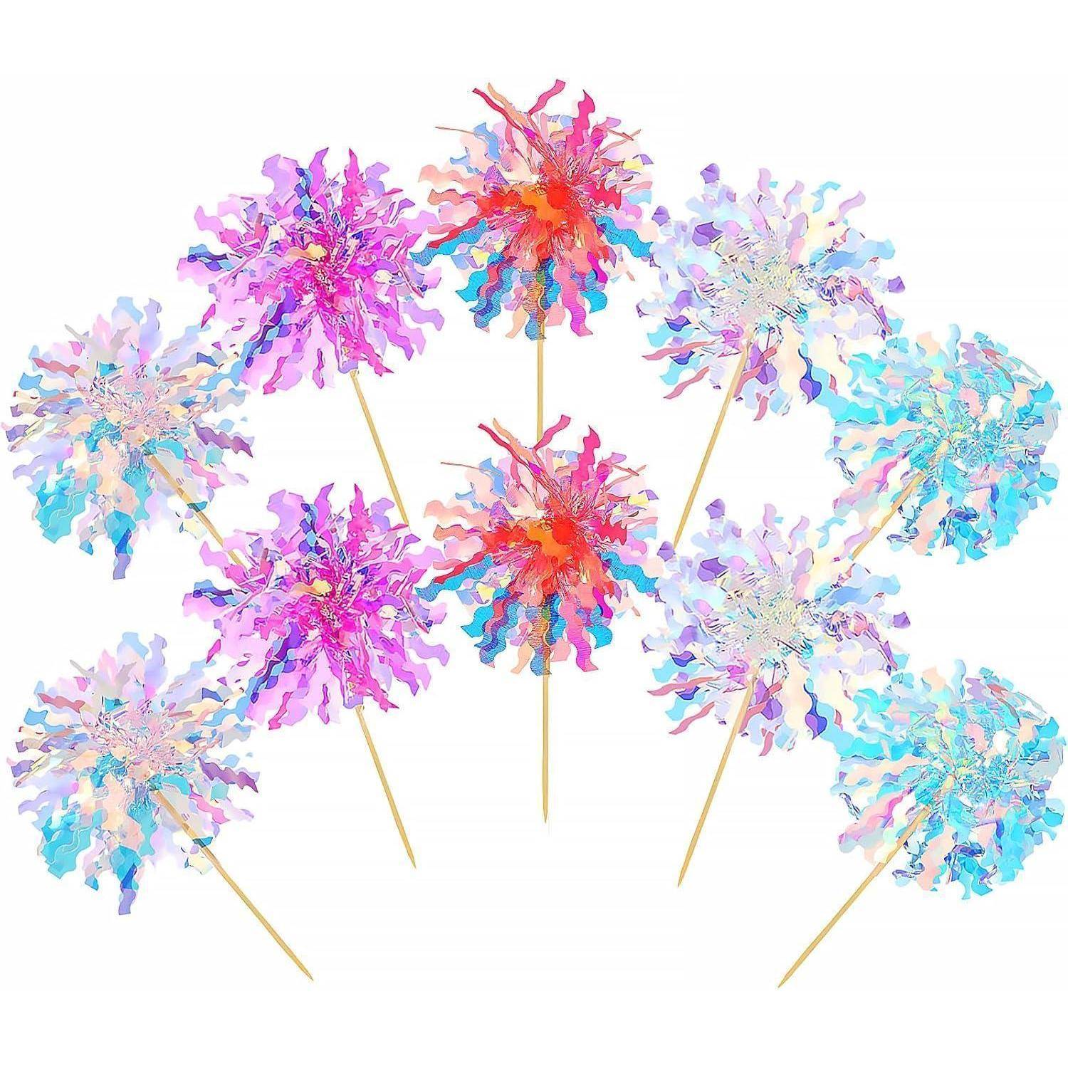 Bunte Pompons an Holzstäben, die funkelnden Feuerwerken ähneln, in einem kreisförmigen Muster vor einem weißen Hintergrund angeordnet.