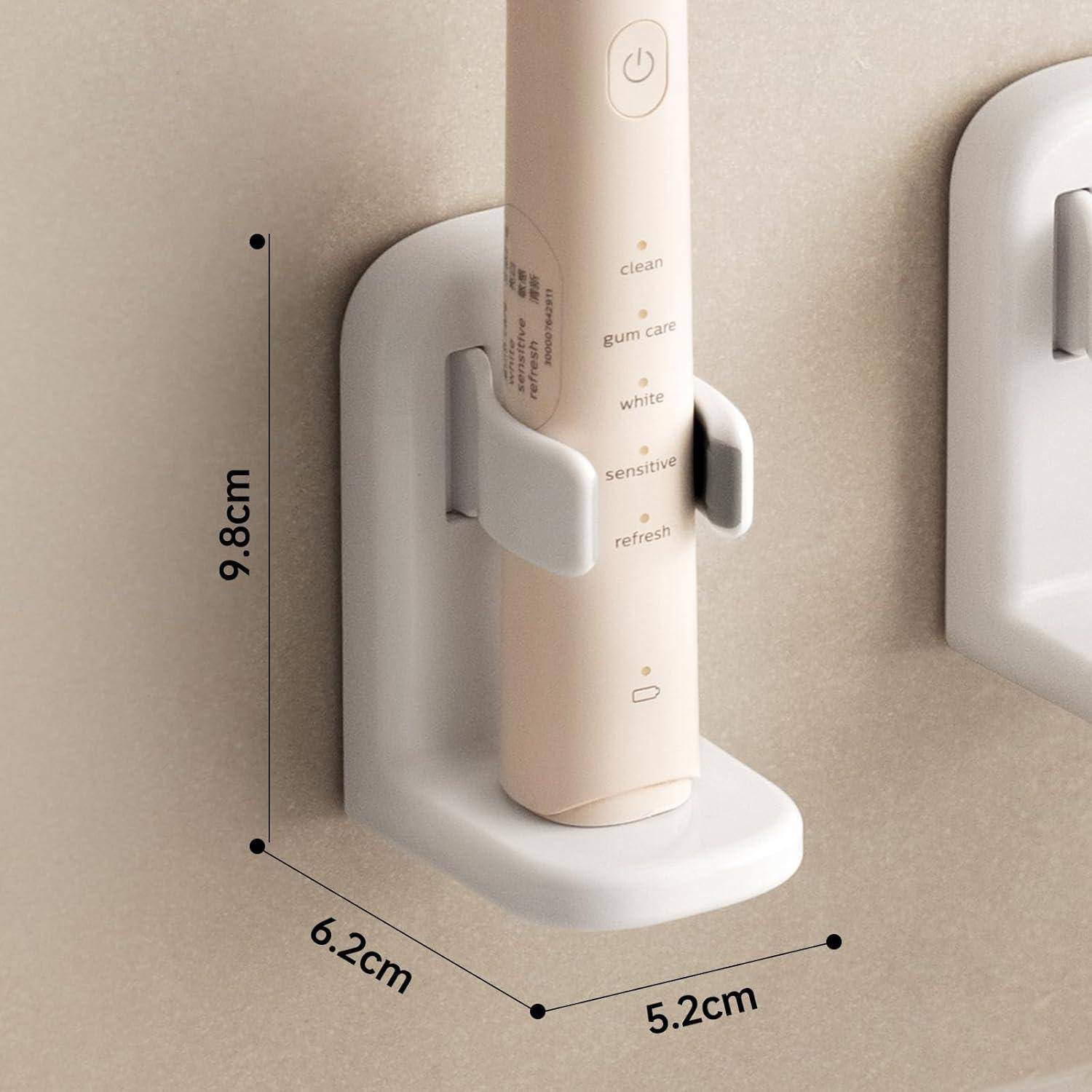 Elektrische Zahnbürste in einem an der Wand montierten Halter, Abmessungen beschriftet: Höhe 9,8 cm, Breite 6,2 cm, Tiefe 5,2 cm; Zahnbürste mit mehreren Betriebsmodi.