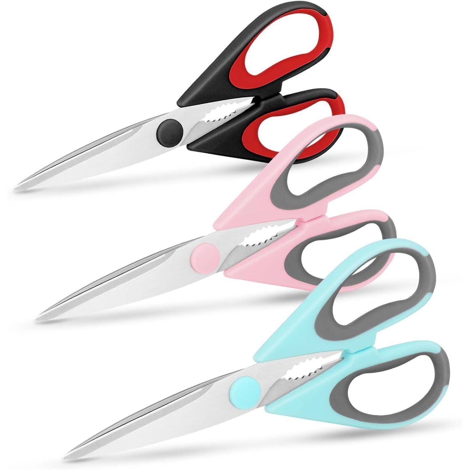Drei Scheren mit roten, rosa und blauen Griffen sind diagonal angeordnet. Jede hat eine silberne Klinge und einen schwarzen oder grauen Griff.