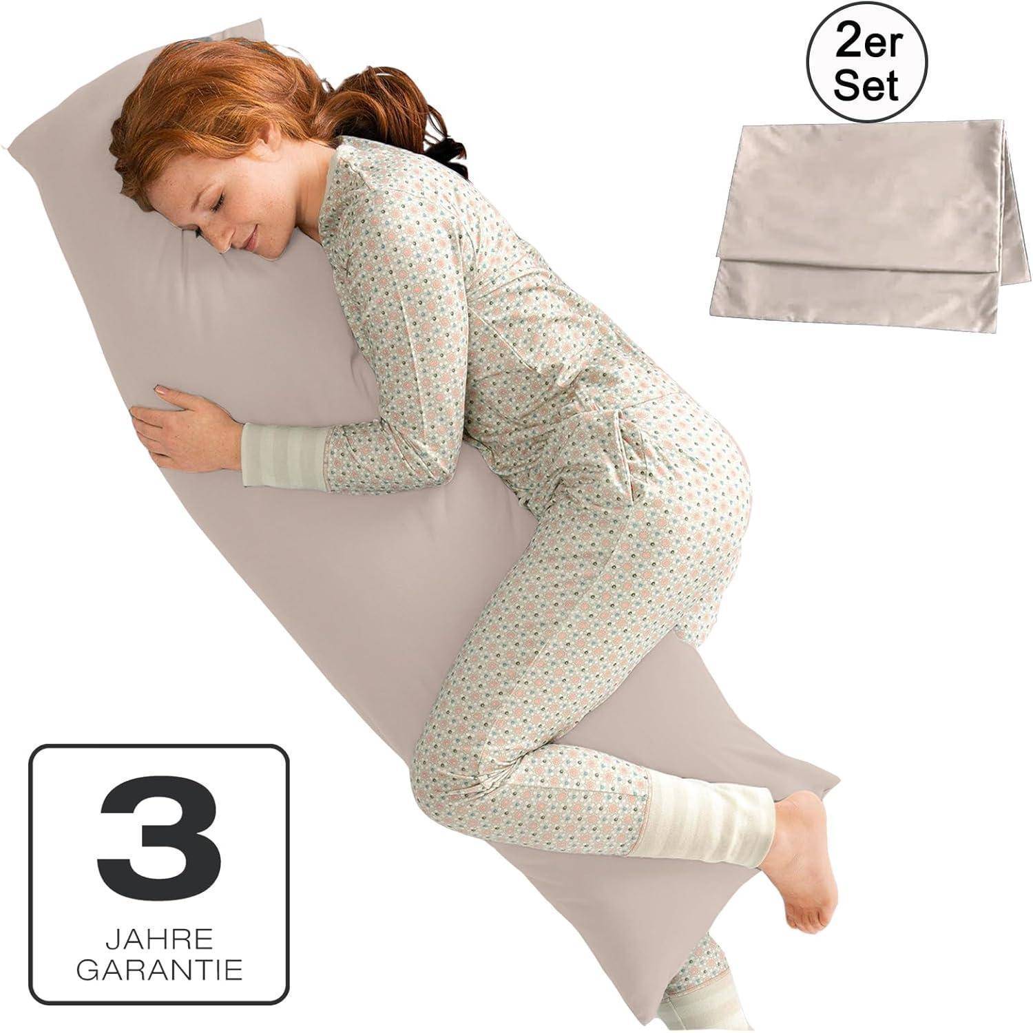 Eine Person in Pyjamas umarmt gemütlich ein Körperkissen. Das Bild bewirbt ein Kissensortiment und hebt ein '3-Jahre-Garantie'-Etikett hervor.