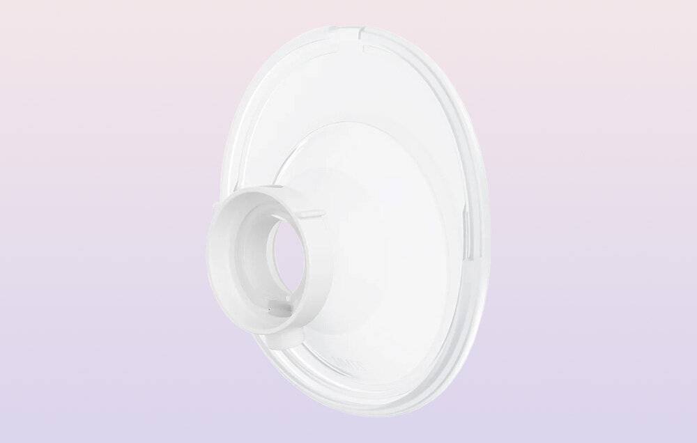 Eine weiße, kreisförmige Stillpumpenbrust-Flansch mit einer konischen Öffnung wird gegen einen weichen rosa- und lila Hintergrund gezeigt.