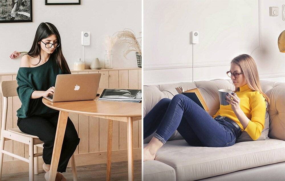 Ein weißer intelligenter Stecker mit doppelten USB-Anschlüssen und Stiften auf der Rückseite zum Einstecken in eine Steckdose.