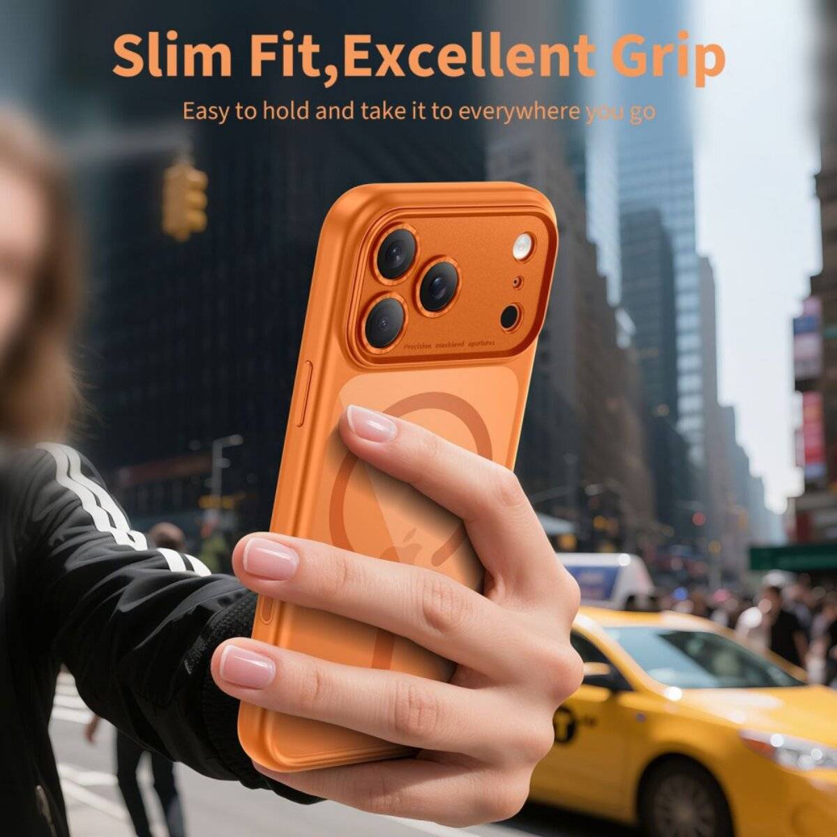 Eine Person hält ein oranges Smartphone vor einem unscharfen Hintergrund einer Stadtstraße. Der Text lautet: „Slim Fit, Ausgezeichneter Griff. Einfach zu halten und überall hin mitnehmen, wohin du gehst.